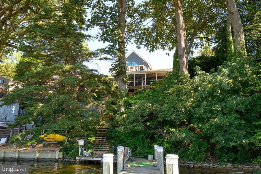 Wymont Park Waterfront Living!
Welcome to Wymont Park, a charming waterfront community on Still Pond Creek that perfectly embodies Eastern Shore living. This one-of-a-kind home has a rich history—originally built as a cozy bungalow, it has grown over the years through thoughtful additions and, most recently, a complete remodel that transformed it into the stunning residence it is today.

With three levels facing the water, this home is designed to maximize the views and the experience of creekside living. Step through the main entrance and you’re greeted by original post-and-beam details that flow into an open living, kitchen, and dining area. These spaces lead seamlessly to a screened porch overlooking lush gardens, your private dock, and breathtaking Still Pond sunsets.

The primary suite on the second floor offers a private walk-out deck, the perfect retreat for morning coffee or evening stargazing. With 3 bedrooms, 2 full baths, and 2 powder rooms, there’s ample space for both relaxation and entertaining.

The walk-out lower level provides additional sitting areas and opens to outdoor living spaces, including a unique wood-fired  oven crafted from the home’s original fieldstone. This area is surrounded by gardens and the relaxing sounds of the fish ponds and waterfalls with peaceful seating to enjoy.

Every update and remodel has been carried out with care, blending modern comforts with the character and charm of the home’s history. From sunrise coffee on the deck to sunset views over the creek, this property offers the ultimate Eastern Shore lifestyle.