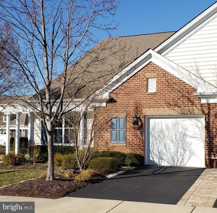 BEAUTIFUL, END UNIT VILLA in the popular Potomac Green 55+ Community!   This all one level, 2 bedroom/ 2 full bath, PLUS DEN property is the perfect space to call home!   This truly is one of the most functional and adorable units around!   The Villa is very private and located on a quiet street, next to additional visitor parking!   The interior features an open concept layout with an abundance of windows to make this space so bright & airy!   Upgraded with beautiful trim work throughout, a cozy custom fireplace, and a bonus sunlit sunroom located behind French doors.   The perfect place to read that intriguing book or daily newspaper!   Beyond that is your private & upgraded stone patio with treed views where you can enjoy nature at its best!   Have a green thumb? You will love it even more!   Ample space to grow your favorite plants or flowers.   Owners suite is spacious with a private bath with dual sinks, linen closet and a large WIC!   Kitchen is a great functional space where you will have plenty room to make your favorite recipes!   Do you enjoy crafts or need an office?   The closed in den can serve so many purposes too!   As you make your way down the hall, you will find a nice large coat closet, custom pantry, and laundry room!   And if you have visiting guests the 2nd bedroom and full bath will give them the best privacy.   Last but not least, is the single attached garage which will give you that additional storage you may need.   Schedule a tour today, you will be so happy you did!   Potomac Green has endless indoor & outdoor activities!   You can participate as much or as little as you want!   *More PICTURES will be in next week*
Pride of ownerships is apparent!   *(2021 Freshly painted)  *(2021 New Stove & Refrigerator)  *(2022 Stone Paver Patio $6500)  *(2023 New HVAC $10k)