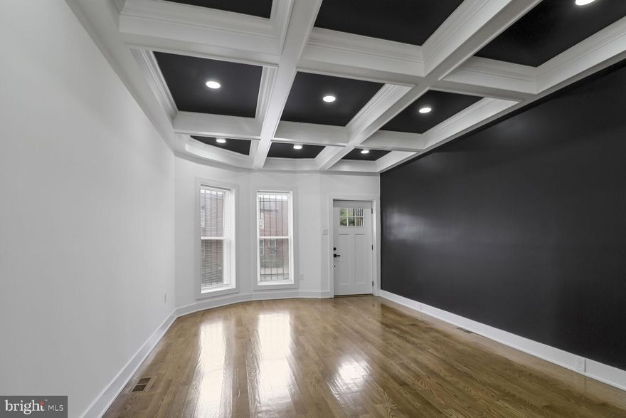 Experience modern living in this beautifully renovated three-level “Swell Front” townhome, where contemporary charm meets stylish design. 

The character of this 1920’s  era architectural design is on full display. The windows feature visually distinct lintels and stone sills, bands of rusticated stone add texture to the facade, and the roofline is accented with a decorative cornice.

As you enter, you'll be greeted by stunning five-inch wide white oak hardwood floors that flow seamlessly throughout the home. The main level living area boasts 9ft ceilings, a striking nine-panel coffered ceiling, enhanced by recessed lighting for an inviting ambiance.

This fully updated townhome exemplifies modern elegance. The gourmet kitchen is a chef's dream, featuring exquisite quartz countertops, stainless steel appliances, and thoughtful finishes perfect for both cooking and entertaining. Highlights include 42-inch cabinets, a breakfast bar adorned with pendant lighting, floating shelves, subway tile, a wine and beverage cooler, and a dedicated kitchen workspace.

The dining room impresses with a dramatic floating box picture frame molding on the ceiling, complemented by dimmable recessed lighting and a chic sputnik chandelier.

On the upper level, you'll find three bedrooms and two luxurious full bathrooms. The primary bedroom is a serene retreat, complete with a charming bay window. Its ensuite bathroom features a pocket door, a walk-in shower lined with floor-to-ceiling tile, a ceiling-mounted rain shower head, spray wand and an elegant shower door.

The hallway bathroom showcases ceiling-high tile and a stylish raised basin sink.

Additional custom features include a powder room on the main level, hardwood staircase with oak treads and risers, five-and-a-half-inch baseboards, solid wood doors, and contemporary fixtures and hardware. The HVAC system was replaced in 2021, ensuring comfort and efficiency.

NO ground rent.