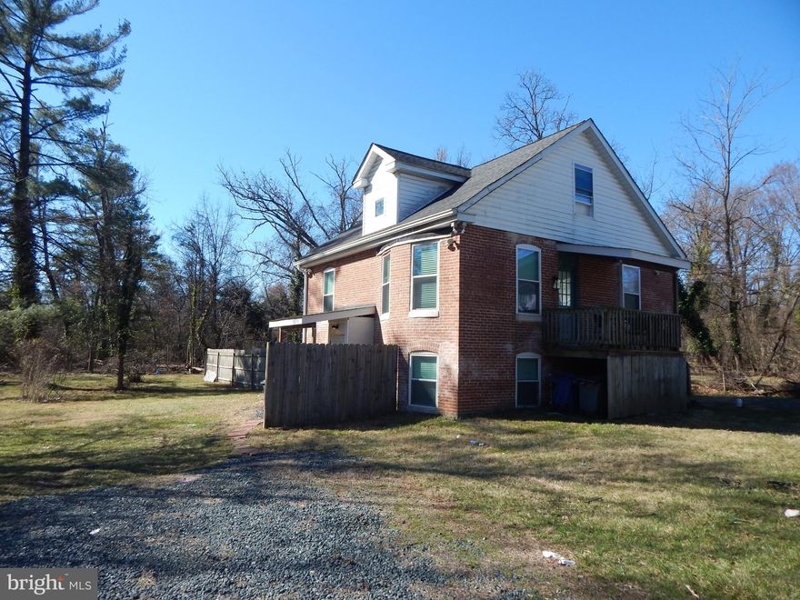 This big, brick Federal-style home is nestled in the woods and sits on almost a full acre of property (.84) Located in Catonsville, this home boasts 6 Bedrooms and 3 Full baths. This home has been meticulously renovated and cared for and is currently set up as a 2-unit and each unit has been  rented via AirBnB for excellent income . The main home is 4 bedrooms  2 Full bath and the basement unit is 2 bedrooms and 1 Full bath.   Can be easily converted back to a single -family home  or live in the 4BR home and rent out the basement apartment for income to pay your mortgage.  Main house has a huge kitchen with plenty of cabinet space and a large living room to relax or entertain.
Surrounded by nature and beautiful trees your property backs up to a bubbling stream.  Enjoy the huge, open backyard that features a large, firepit.  Plenty of  private space where you can start a garden, build a pond or simply and quietly enjoy nature. So wonderful!  The location is perfect for privacy but just minutes from 695, I95, shops, stores and restaurants.  Once you visit, you will call it HOME!