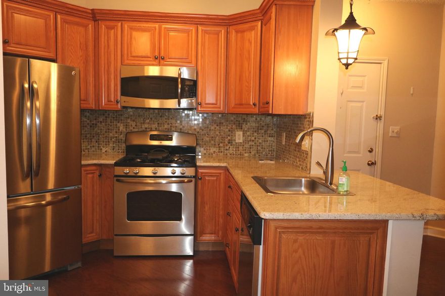 Well maintained unit on the main level offering One Bedroom, One Full Bath with hard wood floor through the main. Beautifully up dated Kitchen with SS appliances, unit offers good amount of storage space a nice size balcony and more storage by the Utility room.