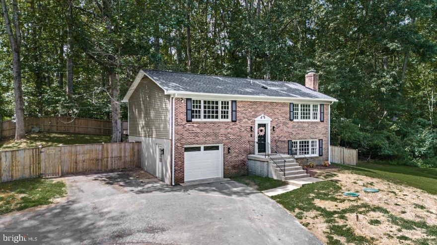 Welcome to 1655 Garrisonville Road, a beautifully renovated brick-front split foyer on nearly 2 acres with NO HOA. The home was completely renovated in 2025, including all major systems, giving you the comfort of a new home with the space and privacy you’ve been searching for. The interior shines with a brand-new kitchen featuring shaker cabinets, granite counters, stainless steel appliances, and a stylish tile backsplash. All three bathrooms have been fully renovated with new fixtures, tile surrounds, and modern finishes. You’ll also enjoy all new plumbing and electrical fixtures, fresh paint throughout, luxury vinyl plank flooring, and new carpet. Major systems are worry-free with a new roof, new siding, new AC condenser unit, and brand-new septic tank and distribution box (2025), plus a new heat pump installed in 2024. Outside, the home is accented with fresh landscaping and a refinished, painted deck, perfect for entertaining or relaxing in your private backyard. With 1.77 acres, there’s plenty of space for gardening, pets, or future projects.  Located in the heart of Stafford, this home combines privacy with convenience—just minutes to I-95, Quantico, shopping, and dining. Move right in and enjoy a turnkey 2025 renovation where all the big-ticket items are already done!