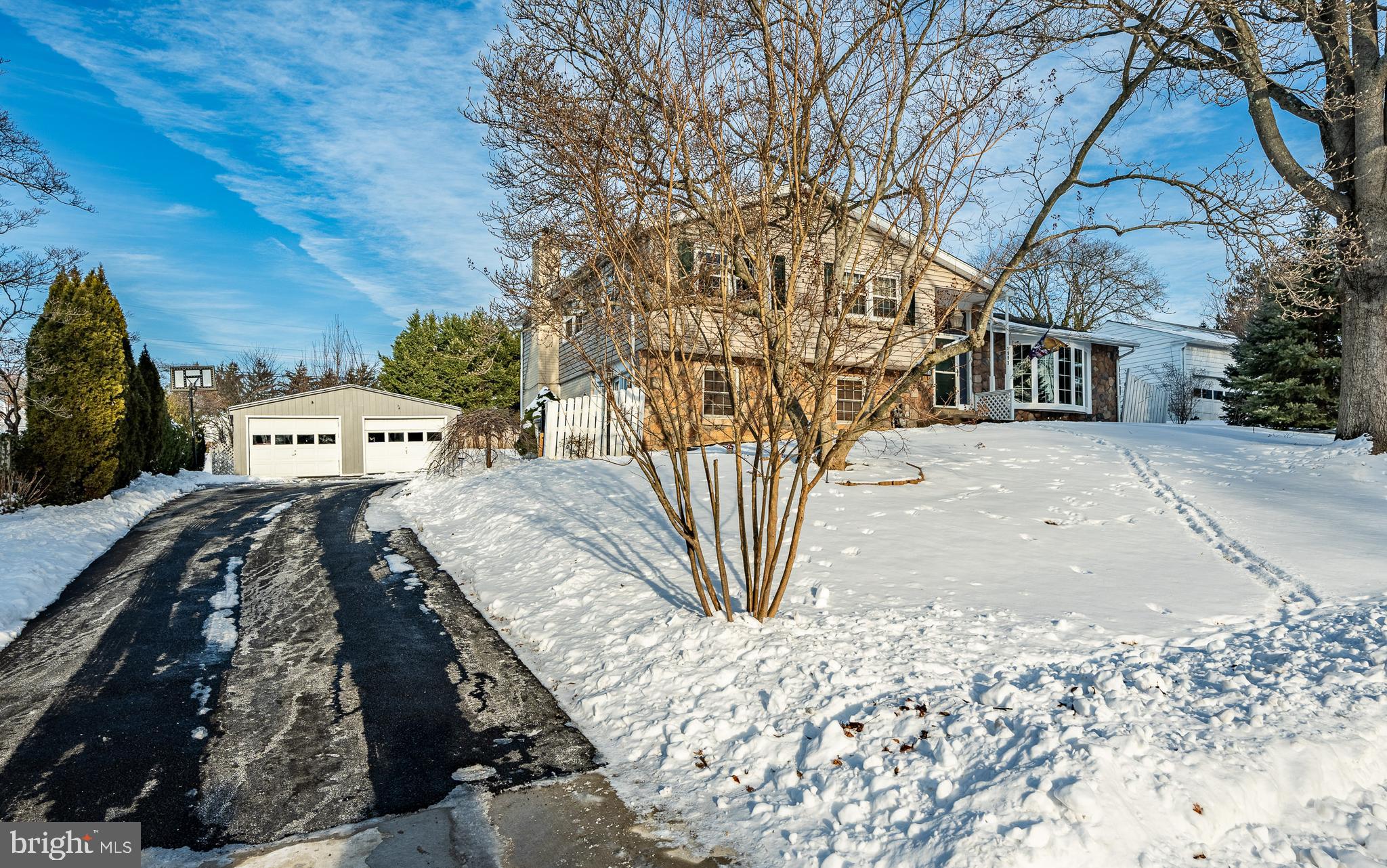 Welcome to this lovely 2636 sqft. home in Westover Woods, Eagleville area. This home offers many upgrades and recent remodels, making this one a pleasure to show. 4 large bedrooms, 2 full and 1 half bathrooms, 2 car detached oversized garages with a lot of storage area, and 2 rear patios for three-season entertaining. The large foyer expands into the open floor plan with a large formal living room with a 5 panel glass bow window, installed in 2024, allowing a lot of natural light into this home. The adjoining dining room offers plenty of space for guests to join you when you entertain, and they both have lovely hardwood floors. You won’t find anything but a blend of engineered hardwood and newer luxury wide plank wood floors in most rooms. The modern renovated kitchen was completely redone in 2015 with coordinating glass tiled backsplash and new granite counter tops. The huge island and abundant counters allow the Chef to entertain and be part of the gathering while preparing meals. Stainless steel appliances include a Double Kenmore Elite Wall oven with lower warming drawer and also a 5 Burner Gas counter top range with custom range hood. A side by side Kenmore Elite refrigerator with lower lever freezer, ice maker and water dispenser, and check out the additional wine chiller regrigerator. There is a double sink, with a side garbage disposal, a stainless Kenmore Elite dishwasher and a built-in microwave below the huge 7 x 4 island. There are lots of glass cabinet doors, 42 inch cabinets, and 2 huge double Pantry closets, one on each end of the kitchen, making this work space a dream come true. The kitchen has 16 x 16 ceramic tile flooring and off the kitchen is an enclosed porch 15 x 12 with a ceiling fan, two heaters and is perfect for year round use. The upper level offers 4 generous sized bedrooms with wood flooring, ceiling fans and many windows. The main bedroom has a remodeled full bath with a ceramic tile custom walk in shower and vanity sink with beautiful onyx tile. The hall bath has also been redone with similar custom marble tile and decorative fixtures. Next, check out the fabulous Lower Level family room, 30 x 22, perfect for large gatherings and entertaining time. A gas or wood fireplace, you decide, with decorative mantel on brick wall is the focal point for this super room. A 2 person Infared Sauna is included with this home, ENJOY!! This room has 6 x 24 ceramic wood tile, many windows and a triple French door to the side driveway area. Another rear door takes you to the 12 x 10 patio just outside the family room with a wood burning fireplace and stone wall area. Also, there is a large crawl space with a concrete floor and walls off the family room area under the main house for additional storage. There is an upper patio 20 x 12 just off the enclosed porch that has a 9 x 9, 7 person hot tub with 56 jets that will stay with the house ( needs a new lid) but works just fine!! There is a laundry/utility room on this level with an Electrolux Washer and LG Dryer, a new hot water heater just installed and a convenient powder room as well. A half-acre lot is just beautiful when in bloom with a Coy pond, fish included, a huge grow your own vegetables and fruits garden, and tons of room to enjoy this space for 3 seasons long. There are many fruit trees, pear, cherry, and a gorgeous Magnolia tree in the front yard. This home is in the perfect location, near golf courses, local shopping, grocery, many restaurants and all major routes closeby. Make sure to set an appointment for this one, you won’t want to miss all the space and beautiful grounds.