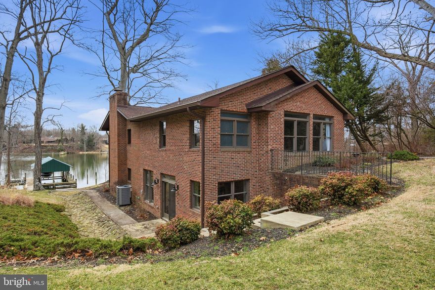 Escape to waterfront living on the Half Pone Point peninsula in Hollywood, Maryland. Nestled directly on Forrest Landing Cove just off of Cuckold Creek, which is a quick boat ride to the Patuxent River and all it has to offer.  This all-brick modernized rambler, which is steps to the water, is on just under 2 acres of land and offers privacy, natural beauty, and deep-water. With approximately 220 feet of shoreline, a pier with a covered 12,000 lb. boat lift, jet ski lift, water, and electric, plus an additional slip with 8’ MLW, this property is a boater’s dream.

The home's approximately 4,400 sf of living space features thoughtful updates and additions, blending timeless charm with modern comfort. The main level showcases oak hardwood floors, a spacious step-down great room with stone fireplace, wet bar, and expansive water views. The gourmet kitchen is equipped with stainless steel appliances, granite countertops, a WOLF range with griddle and grill, large island, and walk-in pantry, all with easy access to the waterfront deck. A formal dining room and seamless flow create the perfect setting for entertaining.  The luxurious primary suite, renovated in 2021, offers vaulted ceilings, dual walk-in closets, and a spa-inspired bathroom with a glass-enclosed wet room featuring dual showers, soaking tub, quartz vanities, and polished nickel fixtures.

The finished lower level provides additional living space with three bedrooms (third bedroom is currently utilized as an office), a recreation room with custom built-ins and fireplace, a “boat prep” kitchen with granite counters, under counter refrigerator and ice maker, plus direct walkout access to the pier.

Other highlights include a two-car detached brick garage with front entry, side door to enter, fenced lean-to kennel, shed, two HVAC systems (new in 2024 & 2025), propane fireplace and stove, Rennai tankless hot water heater (new in 2025), and a roof replacement in 2021. Deer, birds, and other wildlife add to the peaceful setting of this waterfront retreat.  This is a  rare opportunity to own a private waterfront residence in Southern Maryland—ideal for year-round living or as a second home getaway.