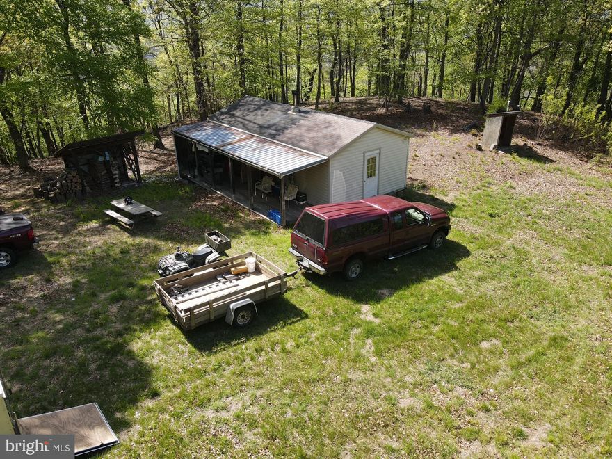 TRUE OFF THE GRID , PRIMITIVE HUNTING CABIN WITH 133.944 UNRESTRICTED WOODED ACRES! THIS PROPERTY IS 2.5 MILES OFF THE COUNTY ROAD. THERE IS A 30 FT DEEDED ACCESS RIGHT OF WAY ROAD MEANDERING THROUGH THE MOUNTAIN SIDE TO THIS PRIMITIVE HUNTING CAMP.  THE CABIN IS ONE LARGE ROOM WITH BEDDING FOR SEVERAL HUNTERS, DINING ROOM TABLE WITH CHAIRS, WIRED FOR BATTERY OPERATED LIGHTS, PROPANE STOVE/OVEN AND HEATED WITH A WOOD STOVE. THE SELLER'S ARE LEAVING 2 PROPANE GRILLS AND OUTSIDE PICNIC TABLE. THE CABIN HAS AN OUTSIDE PRIVY. THERE IS A WOOD SHED AND FIREWOOD CUT. LOOKING FOR THAT SECLUDED PROPERTY TO HUNT, SHOOT AND RIDE YOUR ATV'S, THIS MAY BE IT. THERE ARE HUNTING STANDS ALREADY IN PLACE WITH ATV ACCESS A TO ALL. NUMEROUS LOGGING TRAILS THROUGH OUT THE PROPERTY  FOR ACCESS.