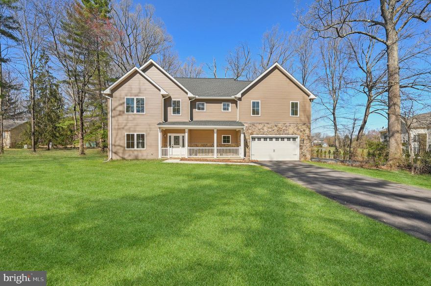 Stunning New Luxury Colonial in Hall Shop Manor

Tucked away in the sought-after Hall Shop Manor community and completed in 2024, this remarkable luxury colonial rests on a sprawling 2-acre lot bordered by mature trees, offering unmatched privacy and breathtaking curb appeal. The exterior showcases a striking blend of stone accents, crisp white trim, and a long, private driveway that sets the tone for the elegance found inside. A welcoming front porch enhances the home’s charm, making it a standout amidst its serene surroundings.

Upon entering, you are greeted by a sophisticated open-concept design that exudes elegance and exceptional craftsmanship. Hardwood floors grace the main level, seamlessly connecting the spacious living room, which is brightened by recessed lighting and cooled by a ceiling fan. The adjacent formal dining area provides an ideal space for entertaining, while a private home office, a stylish half bathroom, and a convenient laundry room with hookups add to the functionality of this level.

The gourmet kitchen is truly the heart of the home, designed to delight any chef. It features sleek quartz countertops, dual sinks, and striking pendant lighting that highlights the expansive island with breakfast bar seating. A chic subway tile backsplash, stainless steel appliances, and ample cabinetry complete this well-appointed space, blending both beauty and practicality.

Upstairs, the luxurious owner’s suite serves as a private retreat, offering plush carpeting, a coffered ceiling, and a generously sized walk-in closet. The spa-like en suite bathroom is adorned with an extended double vanity topped with quartz, complemented by exquisite tile work in the shower, which includes a built-in shelf with an elegant accent strip. This level also includes three additional carpeted bedrooms, one with its own en suite, along with a third full bathroom featuring dual sinks and a welcoming landing area.

The lower level is designed with entertainment in mind, featuring an expansive recreation room that opens to the backyard—perfect for gatherings or quiet relaxation. This level also includes a full bathroom and a versatile bonus area offering abundant storage space.

The outdoor spaces are equally impressive. The inviting front porch overlooks a lush front yard, while the backyard provides a peaceful escape with ample green space that backs to wooded areas, offering shade and enhanced privacy. This serene setting is ideal for enjoying quiet mornings or hosting outdoor gatherings.

Ideally situated in a prime Howard County location, Hall Shop Manor provides convenient access to both Baltimore and Washington. The area is rich with amenities, including shopping, dining, recreation, parks, and the scenic Middle Patuxent Environmental Area. This exceptional home is a perfect blend of luxury, comfort, and convenience—an unparalleled opportunity for upscale suburban living.