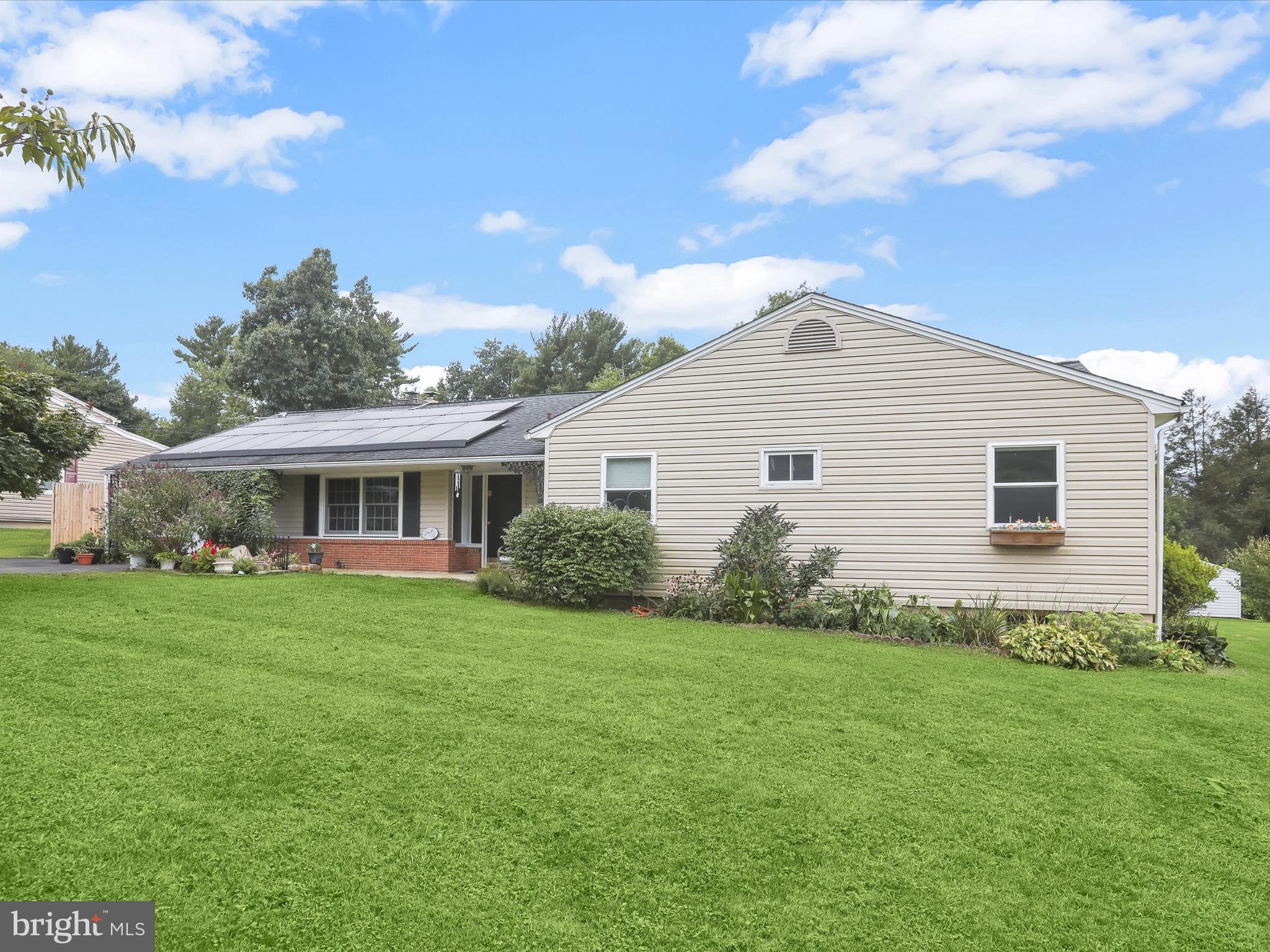 Introducing this three bedroom, two and a half bathroom home set on a peaceful 0.57-acre lot in Kingsville. Exceptionally manicured landscaping and a welcoming covered front porch create a warm first impression. Inside, the spacious living room features hardwood floors, a soaring cathedral ceiling, and a floor-to-ceiling brick surround for the pellet stove. The adjacent dining room is perfect for meals, while sliding glass doors lead to the sunroom overlooking the backyard, complete with a cozy wood-burning fireplace. Prepare your favorite meals in the eat-in kitchen that showcases custom-built Zebrawood and Oak cabinets, Silestone countertops, a tile backsplash, a center island with breakfast bar, and stainless steel appliances including an induction cooktop and double wall ovens. A half bathroom, garage, and access to the basement complete this side of the home. Down the hall, the primary bedroom offers an ensuite bathroom with a walk-in shower and floor-to-ceiling tile. Two additional bedrooms and a second full bathroom with a roll-in shower complete the main level. Downstairs, the unfinished lower level provides endless possibilities for future living space. Step outside to an expansive backyard designed for both relaxation and entertaining, with landscaped grounds, a fire pit, storage shed, and underground electric fence for pets. Recent updates include a new water heater, dishwasher, roof, replaced windows, and more. Leased solar panels further enhance the home’s energy efficiency.