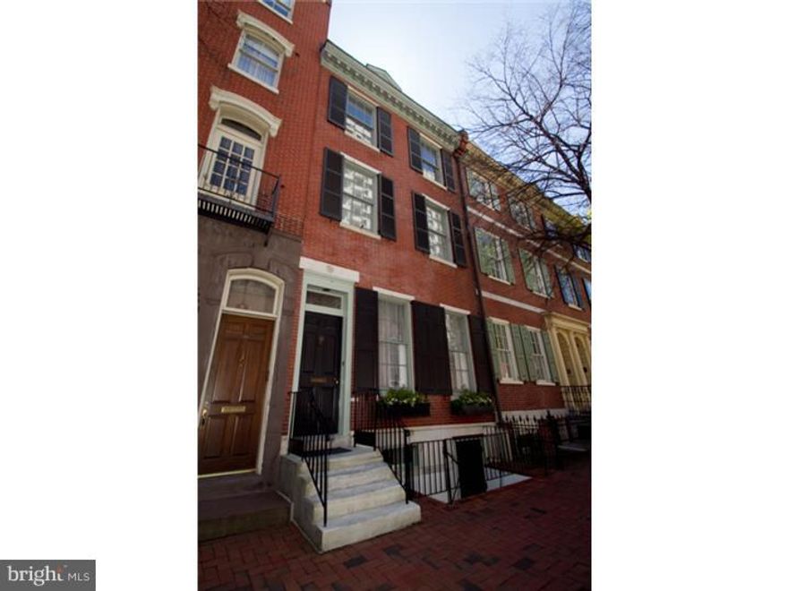 Sophisticated Federal Style Society Hill home built in 1804 blends graceful modern living and historic architecture by offering a designer-renovated master suite and kitchen, all new mechanicals, and two coveted outdoor spaces with parking. A thoughtful renovation in 2013 brings functionality, light and contemporary finishes to this elegant 5 bedroom, 3.5 bath home while preserving the home's original features, such as high ceilings graced with glass-cut chandeliers, marble fireplace mantles, pine floors and the remarkable original circular staircase. Enter through a historic vestibule and the grand hallway into the formal living room and dining rooms each with impressive finely carved gilded mirrors over Victorian-era marble fireplace mantles, stunning hand-cut chandeliers, restored pine floors, and original pocket doors. Bright designer-renovated kitchen boasts a wall of windows, all white custom cabinetry, integrated Subzero, Wolf appliances, and 2 sinks. With a wood-burning fireplace and built-in TV, cooking and dining are a joy in this eat-in kitchen that opens to the red brick courtyard. Fully renovated master suite on the second floor has a five piece bathroom, laundry closet, custom walk-in closet and dressing area all while keeping the architectural integrity of the space intact with its historic wood and marble fireplace mantles, and arched doorways. Second floor has an additional bedroom for guests overlooking the courtyard trees and attached private bath with new Toto toilet. Third floor offers two more bedrooms, a full bath with antique clawfoot cast iron tub, laundry room, and an open den/library with built-in shelves, wood beam ceilings and two wood burning fireplaces. The sun-filled fourth floor bonus room/designer's studio boasts oak-floors and an architecturally unique vaulted wall of windows embracing light from front to back. Roof deck designed for entertaining and gardening with built-in planters, cabinets, water, electric and lighting, not to mention brilliant panoramic views of Society Hill from sunrise to sunset! Once used as a professional office, the basement is finished with new carpet. Mechanicals include 3 new high-efficiency zoned HVAC systems, new gas hot water heater, and water pressure pump. This elegant, once in a lifetime historical, restored masterpiece is nestled in a prime area, just a half block from Washington Square Park, shopping and dining. See attached for more information.