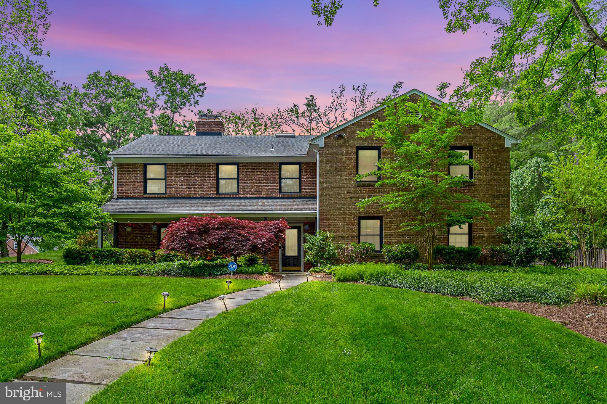 Welcome home to this beautiful brick front home in sought after Ashleigh! Beautifully landscaped with foundational trees and bushes, and a well manicured front lawn. Enjoy a cup of your favorite warm beverage on your welcoming front porch. You'll have plenty of room to grow with 5 beds, 4.5 baths, and 4,601 sq ft of space on over a half acre of land! Walk into a light and bright foyer with convenient coat closet and a full size bath! Walk up the steps to the main living area that features hardwood flooring flowing throughout. The living room features crown molding, built in shelving, and a cozy wood burning fireplace with mantel. Entertain guests easily in the formal dining room that features recessed lighting, ceiling mount, and chair railing. Spacious kitchen features plenty of cabinet and counter space, plus 2 extra large skylights, letting in streams of light throughout the day. Also features a breakfast bar, tile backsplash, cabinet pantry, center island with stovetop, and double sink with detachable faucet and window view. Also features a built in workstation and black and stainless steel appliances appliances, including a wall oven. Enjoy everyday meals in the neighboring breakfast nook featuring a wall of windows and 2 extra large skylights. Relax afterwards in the family room/atrium with cooling ceiling fan, vaulted ceilings, spotlight lighting, and an additional enclave with three walls of windows - one with bench seating. Escape to the main bedroom suite that features vaulted ceiling, plush carpeting, cooling ceiling fan, and a large walk in closet. Also features an en-suite bathroom with double pocket doors and an interior with a spa like experience! Three walls of windows, two separate vanities, large soaking tub plus a stall shower with sky light and two shower heads. A second bedroom with en-suite and 2 bedrooms and hall bath complete the level. The lower entry level is perfect for additional living space. To the left of the entrance is the den that features recessed lighting, carpeting, and a floor to ceiling stone accent wall with a wood burning fireplace. To the right of the entrance is a bedroom - perfect for guests or as an in-law suite! Recreation room is great for use as a home gym or office. Easily entertain in the warmer weather on the spacious flagstone patio with steps to the upper fenced in yard. There is plenty of parking in the attached 2 car garage and long driveway. Ashleigh neighbors are treated to a quiet picturesque setting while maintaining convenient access to every suburban advantage. Nestled between Cabin John Park and the Bethesda Country Club grounds, the home is surrounded by natural beauty. Home is a stone’s throw from Democracy Boulevard, I-270, and I-495 providing an endless supply of dining, shops, and simple commutes for work and play. Do not miss out on this one!