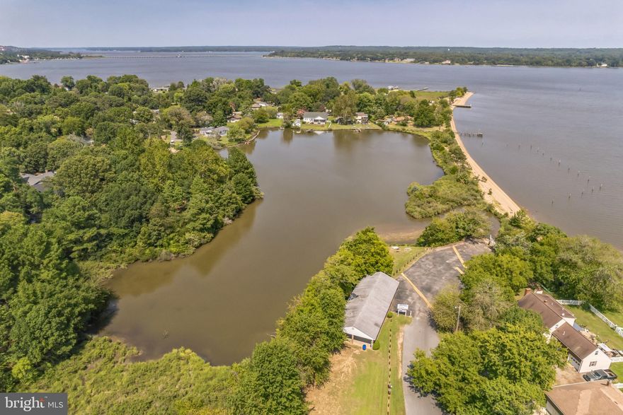 Welcome home to this 4 bedroom, 2 bath home in Golden Beach! The main level of the home has a light and bright feel with tile floors throughout keeping the area cool and comfortable. The kitchen comes fully-equipped with every appliance necessary to make meal prep a breeze and features a prep-island and ample cabinetry and countertop space. The casual breakfast nook is the perfect place to enjoy your morning coffee! The adjacent living room features a wood-burning fireplace and includes double french glass doors to gain access to the outdoor patio space - a great spot for entertaining! The backyard includes two storage sheds for all of your lawn care tools. Past the living room you will find the laundry room and extra storage space/mudroom. A large bedroom with enormous walk-in closets, high ceilings and ceiling fan completes this main level - the perfect spot for guests or as an additional primary bedroom suite. Up the stairs you will find one full hall bath and 3 bedrooms, including the extra spacious primary bedroom with large walk-in closet and private access to balcony space. New septic system and outdoor plumbing has been installed throughout the house! You will love the easy access to community beach, pavilion, playground, picnic areas and boat launch - for only $27 a year! Enjoy close proximity to shopping and restaurants as well as an easy commute to PAX River, Joint Base Andrews and DC. Don’t miss the chance to make this water-community home yours, today!