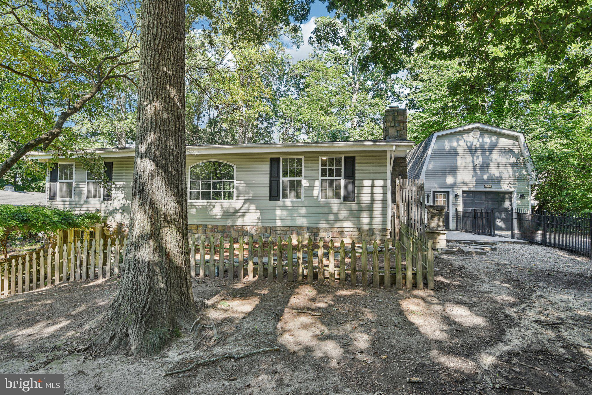 This stunning 4-bedroom, 3-bath single-family home offers over 2,000 finished sq. ft. of living space, perfectly set on a half-acre lot with endless charm and character. Built in 1969 and thoughtfully updated, this property is a rare blend of timeless design and modern upgrades.
Arrive through a long private driveway set back from the road, framed by an 8k wrought iron fence and surrounded by beautiful Cherry Blossom trees, rose bushes, magnolia, and wisteria. A pergola welcomes you at the entry, creating a warm and inviting first impression. The detached 2-car garage with loft and stove provides extra storage or workshop potential.
Step inside through a charming stained glass front door and be greeted by vaulted ceilings that create a spacious and airy feel. Major updates include a 2013 roof, HVAC, water heater, appliances, and electric panel, ensuring peace of mind for years to come.
A unique spiral staircase leads you to the finished walkout basement, complete with fresh paint and flooring, a cozy fireplace, and a Maytag washer/dryer that convey. A French drain system adds practicality and protection.
Your private paradise awaits in the backyard! Enjoy summers around the heated saltwater pool with waterfall spouts and slide, the perfect setting for relaxation or entertaining. A deck, picnic table, and chicken coop all convey, giving you a fully equipped outdoor retreat ready for year-round enjoyment.
Conveniently located in Lusby, this home offers both privacy and easy access to nearby shops, dining, and water amenities. Don’t miss your chance to own this one-of-a-kind property—schedule your private showing today!