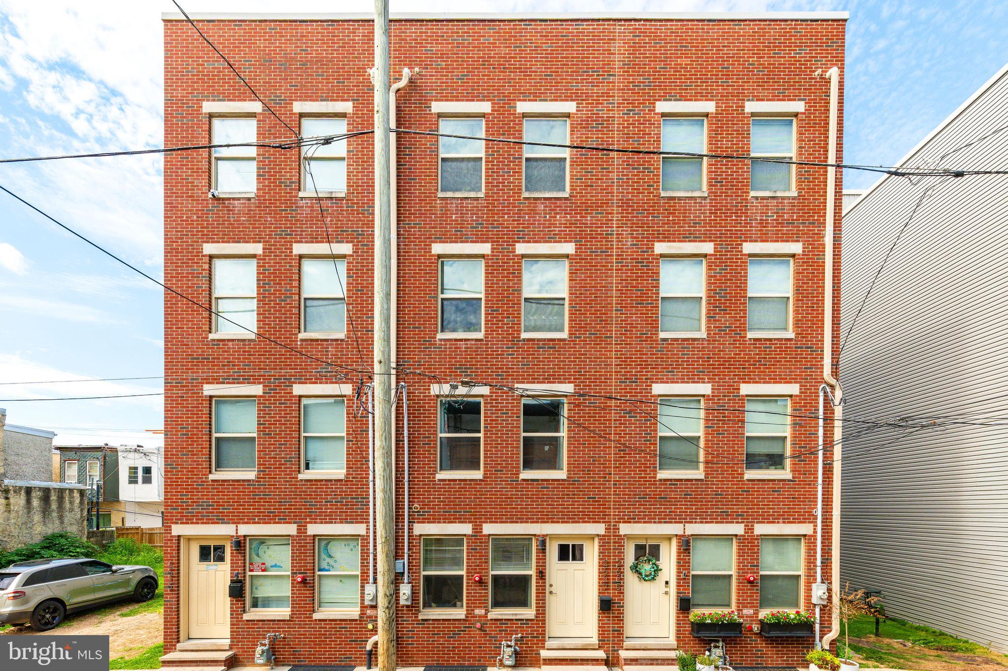 2627 Latona Street | Grays Ferry | Philadelphia, PA 19146
4 Beds | 4 Baths | Roof Deck | 2019 Construction | Nearly 3,000 Sq Ft | 5 Years Remaining on Tax Abatement
Welcome to 2627 Latona Street — a striking four-story brick-front townhome offering nearly 3,000 square feet of modern living space in the rapidly growing Grays Ferry neighborhood of Philadelphia. Built in 2019 and featuring five years remaining on the coveted 10-year tax abatement, this home blends quality construction with contemporary design, multiple outdoor spaces, and an ideal location near Graduate Hospital, University City, and Washington Avenue.
Inside, the home boasts a bright and open floor plan with rich hardwood floors, recessed lighting, and oversized windows that create an airy, welcoming feel across all four levels. The main living area flows seamlessly into a designer kitchen complete with white shaker cabinetry, granite countertops, stainless steel KitchenAid appliances, and a glass tile backsplash — the perfect space to cook, gather, and entertain.
The upper levels offer three spacious bedrooms and three full bathrooms, including a serene primary suite with large windows, a walk-in closet, and a sleek ensuite bath featuring a double vanity and backlit mirrors. One additional bedroom and full bathroom are located in the finished basement, providing a private suite ideal for guests, a home office, or a flexible multi-use space.
Each bathroom throughout the home is thoughtfully appointed with modern vanities, contemporary tile, and high-end fixtures. Central air, ceiling fans, and laundry conveniently located near the upper bedrooms round out the home’s interior comfort and convenience.
Outdoor living is a standout feature, beginning with a private rear patio ideal for grilling and relaxing. A second-floor balcony offers a quiet space for morning coffee, while the expansive roof deck provides panoramic city views and plenty of room for outdoor dining or entertaining.
Conveniently located just minutes from parks, cafes, and neighborhood amenities, and with quick access to University City via the Grays Ferry Avenue Bridge, this home is perfectly situated for city living. Whether you’re looking for a primary residence or a smart long-term investment, 2627 Latona Street delivers on space, style, and location.