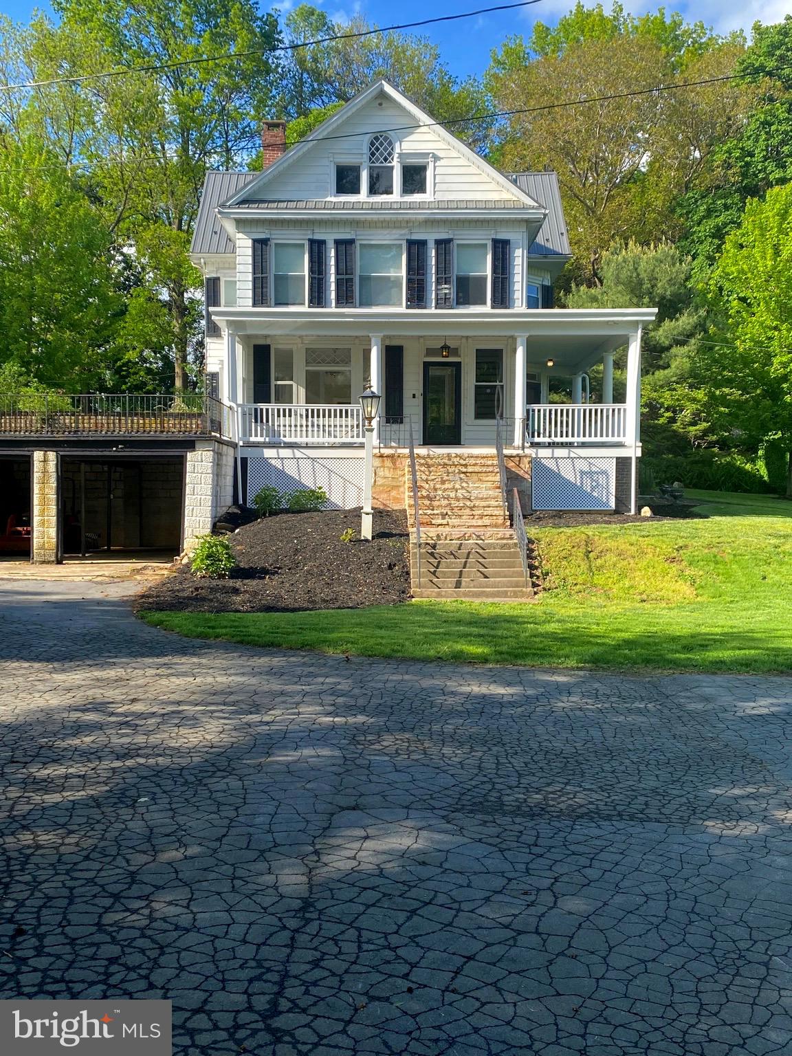 Welcome to 2027 Lincoln Way East, a charming victorian farmhouse dating back to 1903. This home is nestled on over 5 acres with 5 bedrooms and 4 bathrooms, featuring a main farmhouse, an apartment, barn, stable, and beautiful fenced in pastures. Horses allowed! This piece of history is extraordinary as the owners of this home owned and operated Sunnyside Antiques for over 50 years. Driving up the gorgeous tree lined driveway accompanied with stone piers you’ll see the victorian main house that features 3 bedrooms and 2 full bathrooms and a stunning fireplace that goes the whole way to the basement. Luxury vinyl plank flooring has been updated throughout, newer windows and a large wrap around porch to enjoy the mountain views! The apartment in located in the back of the second and third floor featuring 2 bedrooms and 2 bathrooms with 2 doors separating the apartment from the main house. The barn has been home to Sunnyside Antiques for over 50 years with original features and comes equipped with propane wall units and central air as well as recent updated siding and a new roof! Bring your livestock! The shed and stables provide ample space for all your needs! This one is truly a unique find; beaming with history and beauty! Don’t miss it!