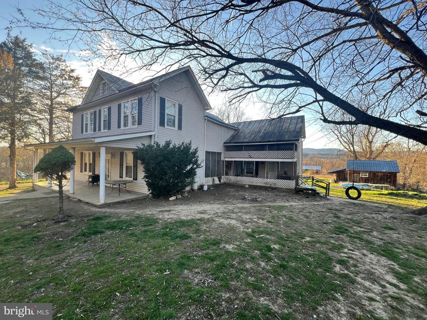 A little TLC will go a long way to make this historic old farmhouse a wonderful home to raise a family and a great little farmette with five fenced acres for livestock. Large pole shelter for family gatherings in back yard. Nice outbuildings. House can be divided/locked on one side for two story apartment, as it has an extra kitchen, porch, living room bedroom and bath. Two staircases. Laundry upstairs. Two and a half baths. Large rooms. Pocket doors. Beautiful mountain views.  Only minutes from Moorefield or Petersburg.