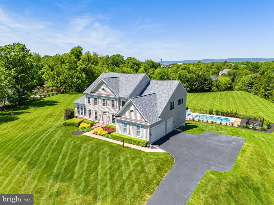 Stately 6BR/4.5BA 6600+ sq. ft. home on 3.4 park-like acres with a brand new pool in an unbeatable Hamilton location. This immaculately maintained retreat is perfect for entertaining and has great potential for multi-generational living with its expansive lower level. Experience gracious living with an open floor plan, hardwood floors, a new roof and HVAC, and a 3-car side load garage.

The gourmet kitchen features wood cabinetry with pull-out drawers, a center island, solid surface countertops, and a spacious walk-in pantry with wood shelves. Appliances include a new Smart refrigerator with LCD touchscreen and wall ovens. Enjoy coffee or wine in the sunny morning room overlooking the pool and pastoral backyard.

The primary bedroom suite offers a large private balcony, huge walk-in closets, and a luxurious en suite bath with dual vanities, a custom shower, a jetted soaking tub, and a private water closet.

The lower level provides numerous opportunities, whether for recreational space to enjoy with friends and loved ones or to create an in-law or au pair suite. Plumbing is roughed in for a wet bar, and hookups are available for a lower level laundry room.

Ivandale is conveniently located near all major commuting routes, just 30 minutes to Dulles Airport and 15 minutes to amenities including the Leesburg Outlet Center, Wegmans, restaurants, local wineries, craft breweries, and downtown festivals.