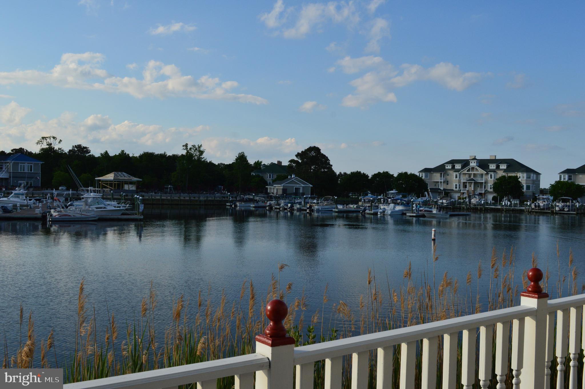 Cape May Seaside Style Waterfront Townhouse in Marina Village. . Popular Floor plan with Huge Master suite, soaking tub, separate shower, double sinks, walk-in closet. Master Bedroom features full bank of windows looking over the Yacht Club Marina. Can see OC and sunrise from the front bedroom sun porch. Furniture and Home Warranty included. New downstairs Outside AC unit and inside coil, New Upstairs outside unit 14.3 SEER Heat pump and new attic air handler upgraded to 5.5 tons, Dishwasher replaced, New garbage disposal , New E rated and hurricane rated sliding glass door in living room. Noise abating glass, New upstairs carpet a few years back, New paint rear deck, New paint front porch, New paint Garage door, New paint in all of the upstairs, New Chamberlain garage door opener, New refrigerator, New plank flooring upstairs bath and laundry room.