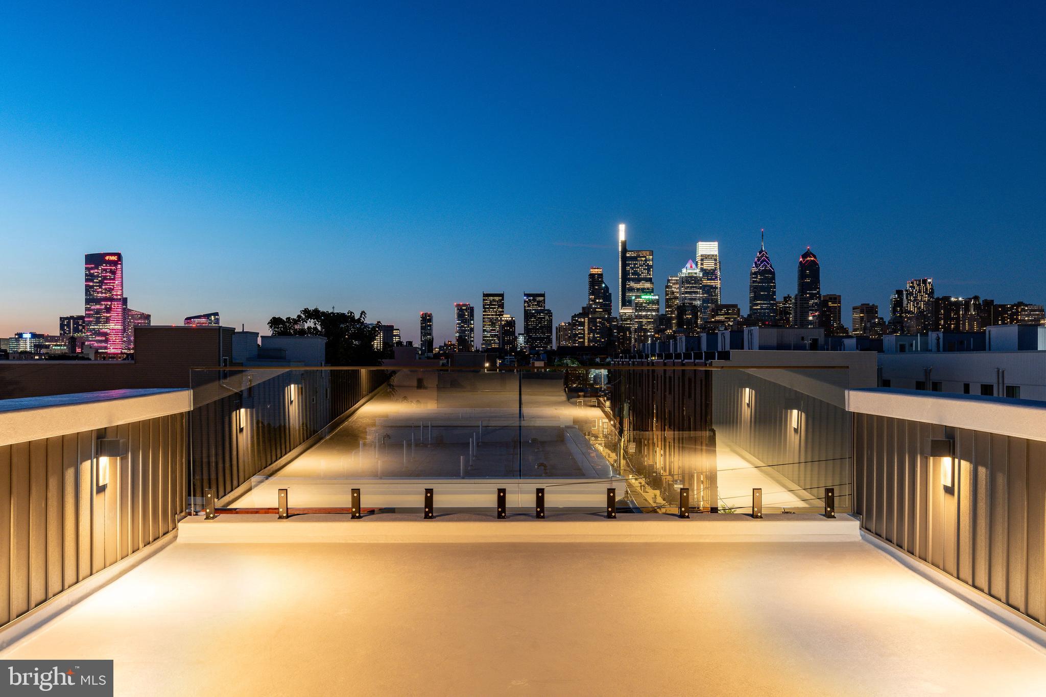 ***FREE 1% Interest Rate Reduction for 12 months. Lower your rate 1% below market rate for Year 1 for qualified Buyers. Preferred Lender is offering a 1% below market, Interest Rate Buydown for the 1st year at ZERO cost to the Buyer!***
2032 Reed Street | A Luxurious New Construction with Skyline Views & 10-Year Tax Abatement in Newbold / Point Breeze
Welcome to 2032 Reed Street, a stunning 4-bedroom, 3-bathroom new construction home with 3,000 square feet of living space in one of Philadelphia’s most vibrant and convenient neighborhoods.
This home offers an open-concept design with wide-plank hardwood floors, a floating staircase with black metal railings, and a custom wood accent wall surrounding the electric fireplace.
At the heart of the home is a designer kitchen with quartz countertops, a full-height tile backsplash, two-tone shaker cabinetry, brass hardware, and premium stainless steel appliances. A large island anchors the space and is enhanced by stylish pendant lighting.
Each of the three full bathrooms showcases high-end finishes, floor-to-ceiling tile, and frameless glass showers. The spa-inspired primary bathroom boasts a natural wood, double vanity with a black marble top and brushed gold hardware. And the showpiece, a massive private roof deck with unobstructed 360° views of the Center City skyline. The perfect oasis for entertaining, relaxing, or taking in stunning sunsets and fireworks displays.
Other highlights include: