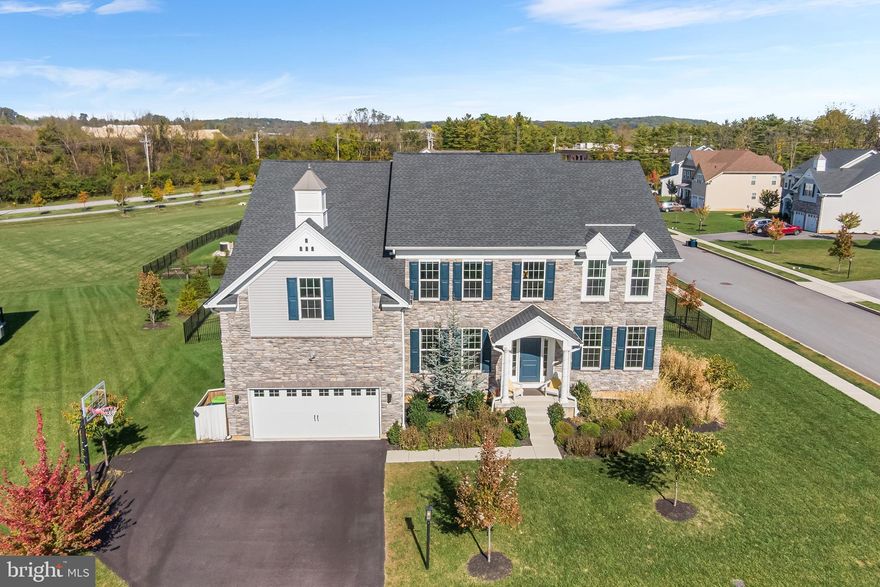 Why wait for new construction? Come experience this marvelous 2021 build in Malvern. Located within the Reserve at Great Valley, 10 Unison Dr is an exceptional five-bedroom, four-bath residence that delivers over 5,000 square feet of sun-drenched, impeccably designed living space. This home is enhanced by significant builder upgrades throughout, including a premium, extra-deep basement with nine-foot ceilings. Inside, discover a grand, light-filled foyer that welcomes you and flows seamlessly into an expansive open-concept living area designed for both everyday comfort and elevated entertainment. The focal point of the home is the custom gourmet kitchen, thoughtfully designed with a massive center island, U-shaped wraparound counters, and a full suite of stainless steel appliances, including double ovens and a gas range with hood. The gorgeous 42-inch soft-close cabinets provide excellent storage along with a sizable walk-in pantry. An abundance of windows floods this space with exceptional natural light, making the kitchen both functional and visually stunning. The adjoining great room impresses with dramatic 20-foot ceilings, a sleek gas fireplace, and a built-in bar, creating an ideal setting for hosting or relaxing in style. The dining area continues the sense of sophistication with a tray ceiling and a statement chandelier that anchors the space beautifully. A full bath and a versatile flex room with a closet complete the main level, offering the perfect setup for a guest suite or private home office. Upstairs, the primary suite serves as a true retreat, featuring a separate sitting area ideal for a nursery, den, or private lounge, along with two large walk-in closets. The spa-inspired primary bath includes dual vanities, a deep soaking tub, and an oversized walk-in shower. Three additional spacious bedrooms—one with its own ensuite bath—are joined by a central loft space and a convenient second-floor laundry room. The finished lower level further expands the home’s living space, highlighted by nine-foot ceilings, a versatile recreation area, a dedicated home gym zone, and ample storage space to meet a variety of lifestyle needs. Outside, pull into the spacious driveway, complemented by a two-car garage and an additional pad that comfortably accommodates multiple vehicles. The outdoor living area is equally impressive, with a professionally landscaped and fully-fenced yard that frames a 900-square-foot Trex deck topped with a premium pergola. This private, green setting provides an ideal backdrop for effortless alfresco dining, entertaining, or quiet relaxation. This community also features a mile-long trail and fully sidewalked streets. Located within the award-winning Great Valley School District, just minutes from premier shopping, dining, and major commuter routes, this home offers turnkey perfection in one of Chester County’s most sought-after enclaves. Schedule your private showing today—and bring your best offer!