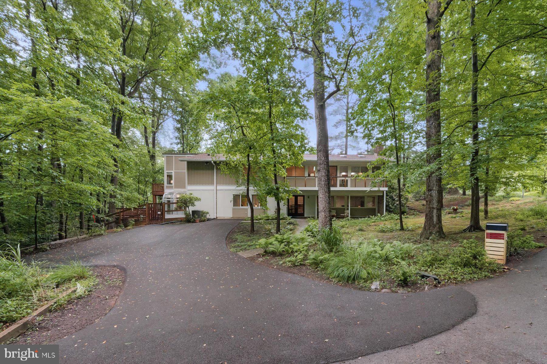 A Mid-Century Modern Oasis in the quiet heart of Carderock Springs! Located on one of Carderock Springs' quietest cul-de-sacs (off quiet Park Overlook Court) and providing your own personal backyard path to the community pool, this expanded Overlook, nestled in the trees, is like living at a mountain resort. An expanded Overlook Model which has a level entry to the upper living level from Park Overlook Court, this home has a rare 6 bedrooms and 4 full baths and nearly 4000 sf. Stunning primary suite addition with fireplace, balcony and luxurious bath will make you feel on vacation every day! 4 full bedrooms up and 2 more on the entry level give you huge flexibility for work from home and guest space or multi-generational living. The entry level boasts the original recreation room and has a second family room added with fireplace, built-ins and greenhouse all leading out to a 24x24 deck surrounded by green space, a completely private and fully fenced yard. The upper level has the classic cathedral ceilings and paneling, a huge balcony with new cable railing system and wonderful warm kitchen which has sliding doors to the patio as does the dining room. This patio is surrounded by a flower garden and also has a gate that leads via a level path to Park Overlook Court. Steps lead down to the main yard which was leveled for a trampoline and has a gate to the path through the community land leading to the Swim and Tennis Club (with summer camp, pickle ball, playground and clubhouse).
This home has 3 renovated baths, an updated kitchen with beautiful granite countertops opened to the living and dining spaces and has had the roof, HVAC, water heater, paint, flooring, carpet and much more upgraded in just the last 5 years!
Carderock is a vibrant neighborhood with many community events including a Chautauqua series of talks, Chili Cook off, holiday events, a dinner group, exercise classes and much much more! Carderock Springs is the preeminent Mid-Century Modern neighborhood in Montgomery County. Prized Carderock Springs Elementary, Pyle Middle and Whitman High School cluster. Close to Cabin John with its shops, gym, grocery convenience and restaurants and the MacArthur bike trail and C & O Canal, Glen Echo Park +++ EZ commute to DC, No VA, Bethesda and the 270 Corridor. Welcome Home!