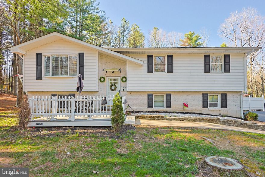 Updated and ready to be your Pocono Retreat. This home is located in Polk Township nestled in a peaceful sprawling forest setting yet close to all Pocono attractions. Featuring newer siding with a sleek modern look and an expansive paved driveway. Step inside to find a bright and inviting living space with newer flooring throughout. The kitchen is equipped with granite countertops, stainless steel appliances, a breakfast bar, pantry closet, and popular white cabinetry, making it both stylish and functional. The main level includes three spacious bedrooms and a full bathroom with tiled shower stall. The lower level is fully finished and currently used as a fourth bedroom, but offers flexible space for a family room, guest suite, or home office. Lower level also features a full bath, laundry room and walkouts to a paver patio that opens to a serene wooded backdrop. Additional highlights include a built-in two-car heated garage, central air, newer septic system (2021), new hot water heater, smart toilets and updated electric panel. This property offers the perfect blend of modern updates, functional space, and tranquil surroundings call today for your private tour.