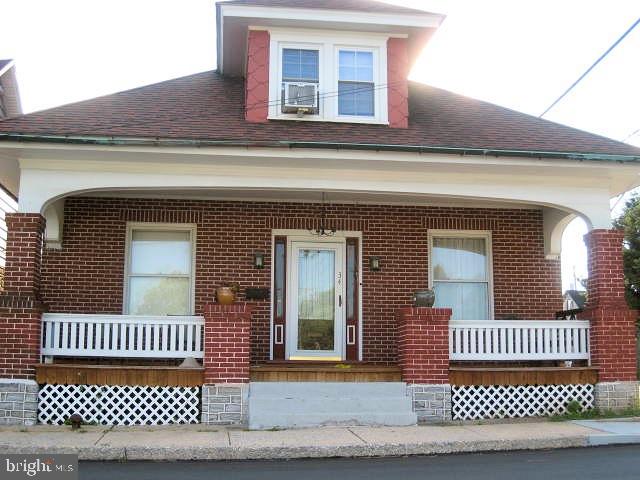 Yesteryear charm fills this tranquil brick boro home on a corner lot w/amenities just a sidewalk stroll away. Nice size yard w/patio & the convenience of a 3-car garage. This 1925 American Four Sq Craftsman style home has many original details & fixtures from the period wide porch the length of home, original hardwood flooring, baseboards, trim, doors & windows, original lighting fixtures, transom windows with brass hardware copper rain gutters, high-end wood pellet stove & an oil fired hot water furnace. This beautiful home is very spacious and affordable and you'll love living in the quaint community of Hummelstown.