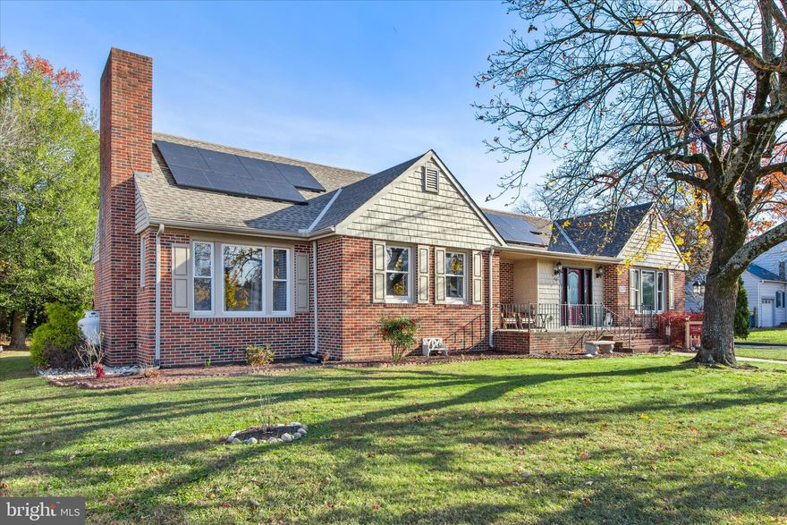 A storybook brick home rich with timeless charm, this traditional residence is gracefully set in a picturesque setting where classic character meets thoughtful modern updates. From the moment you arrive, the inviting front porch and carefully tended landscaping create a warm and welcoming first impression.

Step inside through the front door with decorative glass sidelights to find warm wood flooring that flows seamlessly into the formal dining room and living room. The dining room is beautifully appointed with chair railing, crown molding, and wainscoting, offering an elegant space for gatherings and celebrations. The spacious living room is filled with natural light from abundant windows and features exposed ceiling beams, rich wood floors, and a cozy fireplace that anchors the room with warmth and character.

The kitchen has been refreshed with newly painted cabinetry, granite countertops, and stainless steel appliances. Abundant cabinet space and an adjacent breakfast room make this area both functional and inviting. The breakfast nook, updated with light, fresh paint, offers additional storage and a charming spot to start the day. Some laminate flooring was installed approximately one year ago, adding durability and style to key areas of the home.

A unique and convenient flow continues through the laundry room, which features its own gas wall fireplace and direct access to the two car garage, side patio, and backyard patio. This thoughtful layout creates a comfortable loop through the home, seamlessly connecting daily living spaces.

The home offers three bedrooms and a hall bath with a tub and shower combination. The primary bedroom includes an attached bath for added privacy. One secondary bedroom stands out with wood floors, warm wood walls, built in shelving, a brick gas fireplace, and a large picture window that fills the space with natural light. The third bedroom also features wood flooring and wood walls, continuing the home’s cozy and classic aesthetic.

Outdoor living is equally inviting with a side patio off the laundry room and a large rear patio overlooking the backyard, perfect for relaxing or entertaining. Additional features include a two car garage, leased solar panels, a spacious attic with an attic fan, and a partial basement ideal for storage. The HVAC system was replaced in 2017, offering peace of mind.

Located just a short distance from the quaint town of Milford, you will enjoy easy access to local shops, eateries, and the scenic Milford Riverwalk, all while being less than an hour from the beautiful Delaware beaches.

This storybook dream of a home is ready to welcome its next chapter. Schedule a showing today and experience the charm, warmth, and character for yourself.