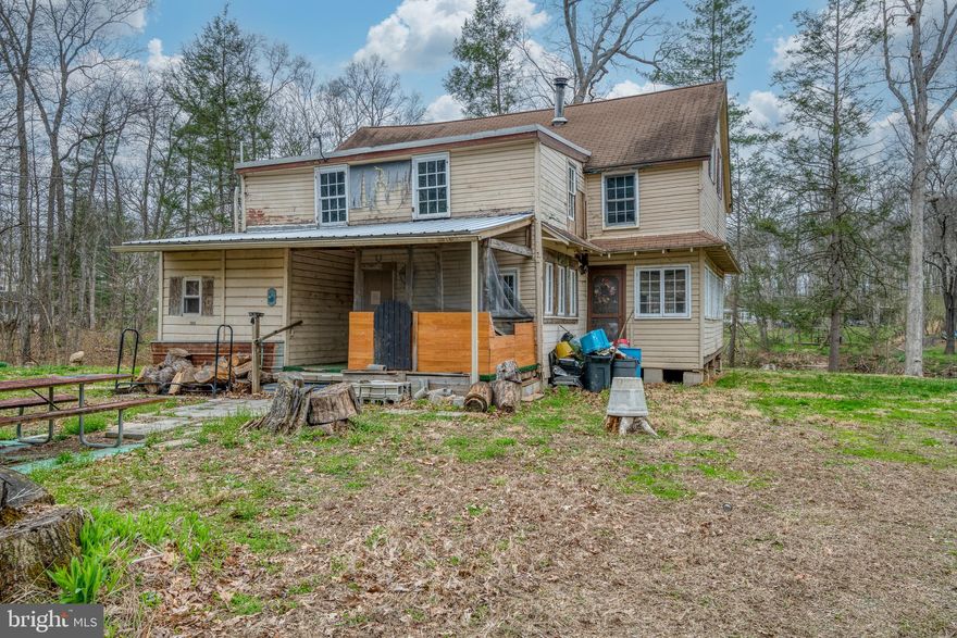 Bring your ideas and vision and make this home shines again! The house sits on a 1.85 acre lot with beautiful scenery with flowing creek. A large detached garage also included. This is a great opportunity with tons of possibility.