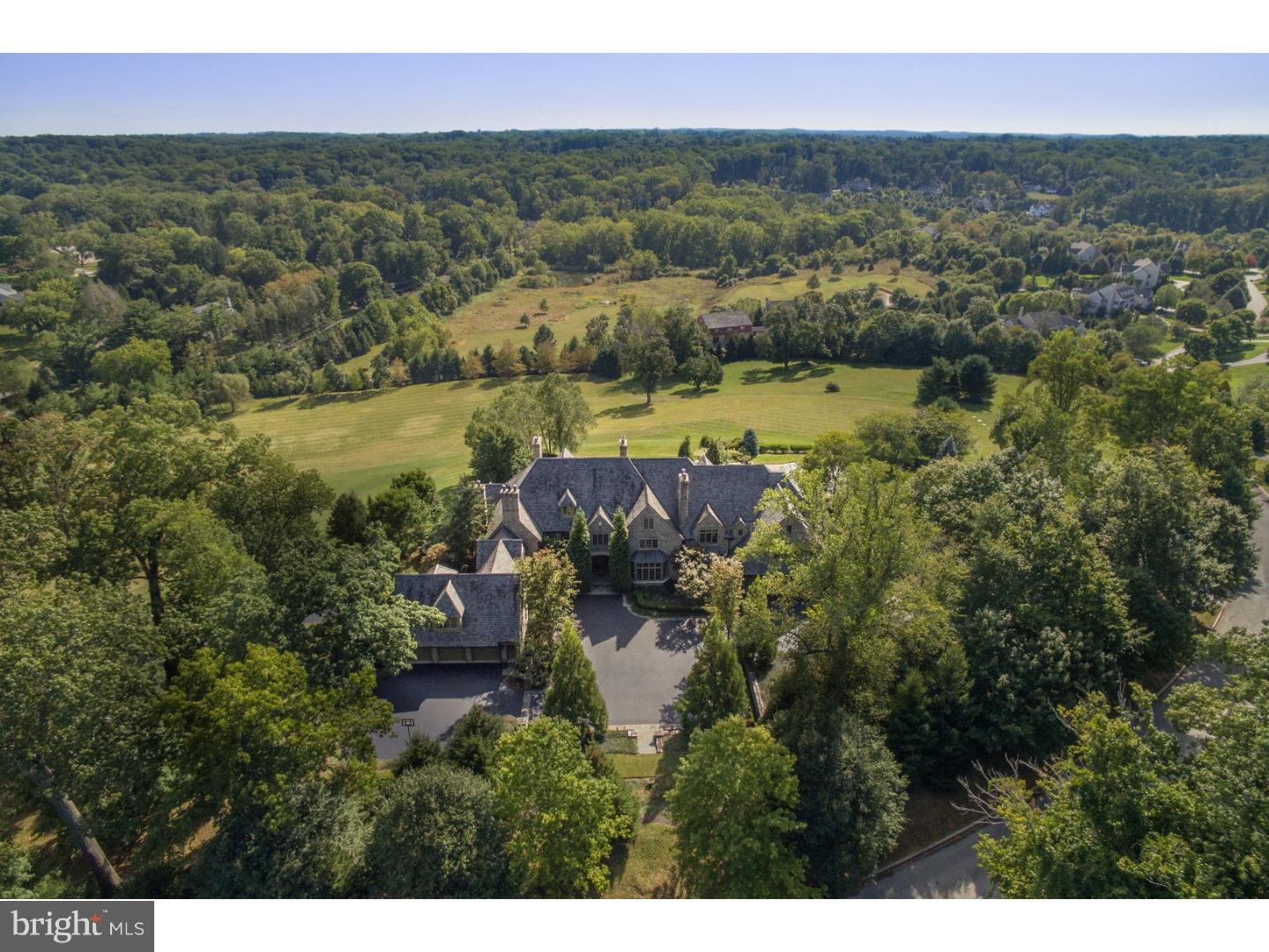 This spectacular English Manor Home offers a rare bend of superior old world stone construction with the finest modern amenities and refinements throughout. Set on a breathtaking 12.7 acre lot with sweeping views of the endless countryside at every turn, it offers complete privacy, yet is located within minutes of renowned schools, Center City Philadelphia, the airport and more. Rarely does an Estate this special become available featuring stunning architectural designs, incredible millwork and moldings, timeless materials and sophisticated finishes throughout. This gracious residence seamlessly combines carefully designed formal living spaces with warm, every day functionality and an easy open flow for all venues of entertaining. Features include 10' ceilings throughout the first floor, 9' on the second floor, solid quarter sawn oak floors, incredible expanses of floor to ceiling windows and French doors capturing the fabulous grounds, gardens, terraces, pool and vistas at every turn, expansive Gourmet Kitchen with a 3" butcher block island, gracious Living and Dining rooms with gas fireplaces, Rich cherry Billiards Room and Library, luxurious Master Suite, 5 additional bedroom suites including a separate In-Law suite with Kitchen, 6 car garage spaces and more. Move right in and enjoy.