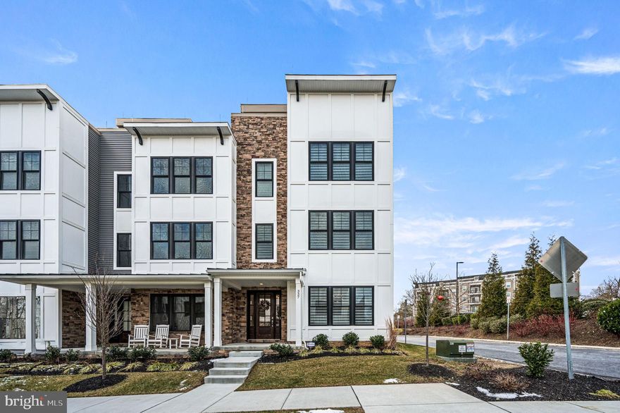 Luxury living at its finest in this move-in-ready end-unit townhome located in the highly sought after Towns at Newtown Walk. This exceptional 4-level residence offers 3 spacious bedrooms, 3.1 bathrooms, and every top-of-the-line upgrade imaginable. Enjoy the convenience of a 4-stop wood-paneled elevator, a fully painted 2-car garage with epoxy flooring, and custom overhead storage. The entry level welcomes you with a stylish foyer and a versatile bedroom or home office complete with a full bathroom. The second floor boasts a contemporary open-concept layout featuring a bright and airy family room and dining area. The gourmet kitchen is a chef’s dream—highlighted by an over sized island with wood accent siding, sleek quartz counter tops, a Café French-door refrigerator with gold trim, wall oven, wine cooler, and a custom wood range hood. The adjacent living room features a stunning linear gas fireplace with a tiled surround and built-in custom cabinetry. Designer finishes throughout include upgraded cabinetry, Ferguson lighting fixtures, recessed lighting, brick tile feature walls on each landing, solid wood doors, and Hunter Douglas Pirouette blinds with remote-controlled blackout options. The luxurious primary suite offers high-end designer wallpaper, a custom walk-in closet, and a spa-inspired en-suite bath with frame less glass shower doors and a rainfall shower head. A third bedroom with its own en-suite bath and custom walk-in closet completes this level. The crown jewel of this home is the rooftop terrace—an entertainer’s paradise featuring an outdoor kitchen with a 36” gas grill and side burner, refrigerated cocktail bar with sink, mounted waterproof TV, Bose speaker system, Arhaus gas fire pit, and an electric pergola with integrated ceiling fan and lighting. Located just steps from the brand new Village at Ellis Preserve Town Center, you’ll enjoy unmatched walkability to dining, shopping, and more. This is truly a rare opportunity to experience upscale, low-maintenance living in the heart of Newtown Square. (Please refer to the included upgrade sheet for a full list of enhancements.)