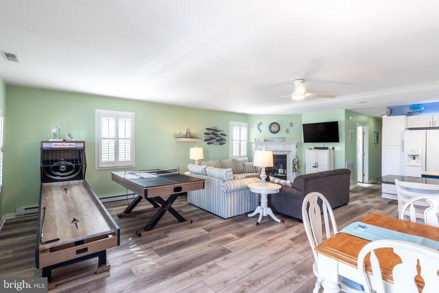 Welcome to this STICK BUILT RANCHER (not a mobile), so it can be easily financed and insured, in the highly sought after Montego Bay neighborhood in North Ocean City. This property is located in zone X, so no flood insurance is required. 
--Why buy a condo with all of the fees when you can own a house with plenty of room to entertain and low carrying costs!
 This stick built home with 2x6 framed construction is well insulated and features a totally open floor plan, brand new luxury vinyl plank flooring throughout, new Blue Pearl granite kitchen countertops, new composite decking ramp to the side door, and a whole house sound system with blu-tooth connection.  The smart thermostat and door lock can be controlled from your phone with wifi connection. The dining room provides plenty of seating for you and your guests. A spacious primary suite has a new king size Sleep Number bed and primary bathroom with a Jacuzzi jet tub.  Enjoy the sunrise on the covered concrete porch with sunlight beaming through the custom shutters into the main living area which includes 2 queen sleeper sofas and a twin pull out loveseat for extra sleeping.  The second bedroom has a twin over full bunk and a twin pull out sleeper loveseat.  The third bedroom has a queen adjustable bed.  The main bathroom has a step in shower with seating and grab bars.  The laundry room has a full size washer and dryer and still has plenty of room for storage and shelving.  *The home was never used as a vacation rental. It is set up to be though with locking cabinets and keyed primary suite.
This home is being sold fully furnished and turn key with all you need ....from the bicycles in the large attached shed, beach chairs for relaxing, 4 televisions, skee-ball and ping pong/air hockey table games and so on....even down to the kitchen utensils, outdoor gas grill, porch furniture, and the sheets/comforters that you will need!  Just unpack your clothes and toothbrush!  For one of the lowest HOA fees around, $396 a year,  Montego Bay boasts 2 in-ground swimming pools  and  a kiddie pool,  2 tennis courts, pickleball, miniature golf, a boardwalk on the bay with 3 fishing piers, a wildlife sanctuary w/ a saltwater pond and walking/jogging path and quiet streets for long walks. The close proximity to Northside Park and Gorman Avenue Park puts you in the PERFECT location on a well maintained grassy corner which provides lots of extra parking for your guests.  Corner lots are community property and cannot be built on.  This property is only an 8 minute walk to the beach and even less of a walk to many local restaurants!