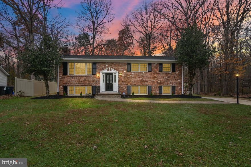 **Open House - Saturday 1-3 pm, Sunday, 12-2 pm** Step inside this spectacular, fully renovated home—truly move-in ready and waiting for its next owners! This spacious split foyer has been thoughtfully updated from top to bottom, featuring stunning LVP flooring, brand-new carpet, a NEW roof, NEW HVAC, and a NEW hot water heater for total peace of mind. The gourmet kitchen shines with quartz countertops, stainless steel appliances, and all-new cabinetry—perfect for cooking, hosting, and everyday living. The main level offers a serene primary suite complete with a beautifully updated bath and generous closet space, along with two additional bedrooms and a second fully renovated full bath. The lower level is an entertainer’s dream, boasting an expansive family room anchored by a charming wood-burning fireplace with a classic brick hearth. A fourth bedroom with an adjoining den—ideal as a 5th bedroom, office, or hobby space—provides excellent flexibility. You'll also find a large storage area and a dedicated laundry space. Outside, enjoy a picturesque, park-like setting backing to mature woods for privacy and relaxation. An oversized shed adds even more functionality to this incredible backyard. This one checks all the boxes—renovated, spacious, private, and beautifully finished throughout!