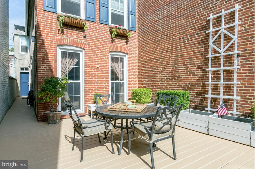 Price Reduced: Location, location! TH features spacious front yard w deck & planters.  Many windows let in ample light*newly refinishd orig flrs on main*9ft ceilings*wood burning FP*Enviable kitchen complements orig tin ceilings*transoms. 2 bedr+ office  full bath & W/D conveniently on bedrm level. Compact car parking pad. In the heart of Federal Hill, close to Inner Harbor, UA, hospitals & more.