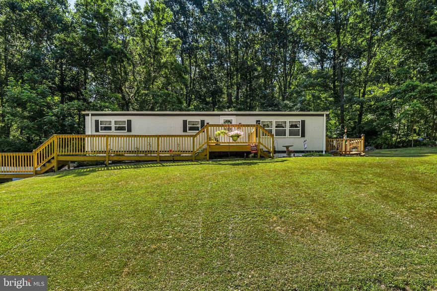 Welcome home to 12023 Woodland Dr! A charming family home featuring a bright living room, cozy family room, and an eat-in kitchen with deck access. The spacious bedrooms give plenty of room to spread out, and the 1-acre lot provide comfort and privacy. Enjoy the convenience of a hot tub on the first floor and an attached two-car garage in the lower level. With close proximity to schools, parks, and shopping, this home offers modern amenities in a serene neighborhood with easy highway access. Updates include a 2023 new roof, new windows, new storm doors, and much more. Schedule your showing today!