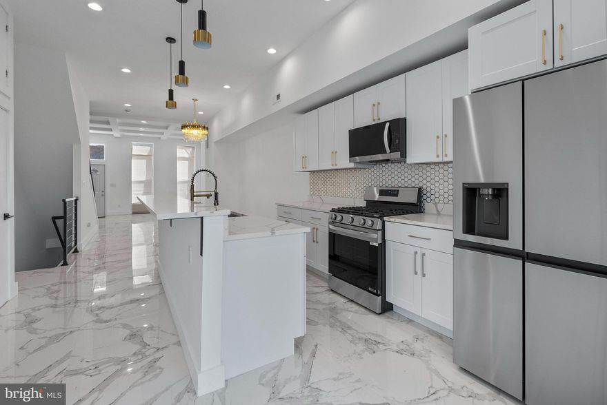 Welcome to 1818 McCulloh St! This spacious, fully renovated 5-bedroom, 5.5-bath townhome blends style and sophistication. Step inside to luxurious marble flooring, abundant natural light, and stunning coffered ceilings. Leading to a gourmet kitchen with sleek quartz countertops, stainless steel appliances, and a deep sink. The open-concept layout is perfect for entertaining. The second level features two spacious en-suite bedrooms and a conveniently located washer & dryer. On the third level, you'll find two additional en-suite bedrooms, including the luxurious primary suite, complete with a spa-like bathroom designed for ultimate relaxation. The fully finished basement offers even more living space, including an additional en-suite bedroom—perfect for guests or family. Step outside to an oversized deck, a fenced yard, and a two-car parking pad. Conveniently located near shopping, dining, and commuter routes.