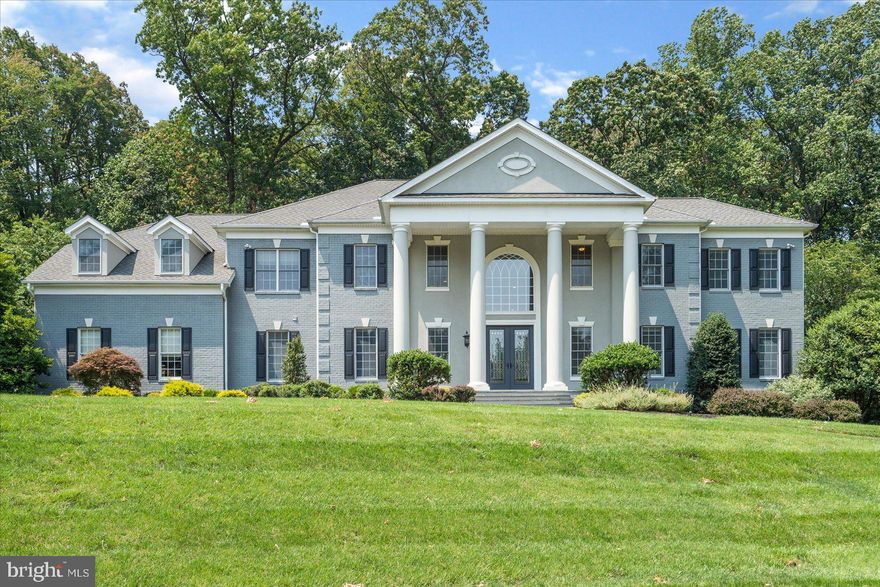 Gated enclave of gorgeous homes in a magnificent setting.  The location is close to everything and yet feels like its a world away,  as you are tucked back on a private gated court.  Sitting perched on 2 acres of landscaped grounds, the circular drive leads you in to the imposing front with its 20 foot columns and grand covered entry.  Once inside, you will be awed by the grand open space and radiant sunlight that bathes each and every room.  There is no shortage of family and entertaining space in this 5 bedroom home, which includes two home offices, huge theater, grand open kitchen family room area, breathtaking master suite with sitting room, fireplace, cove lighting, dramatic bath and dressing  ..... and so much more.  8,000 square feet of living!!