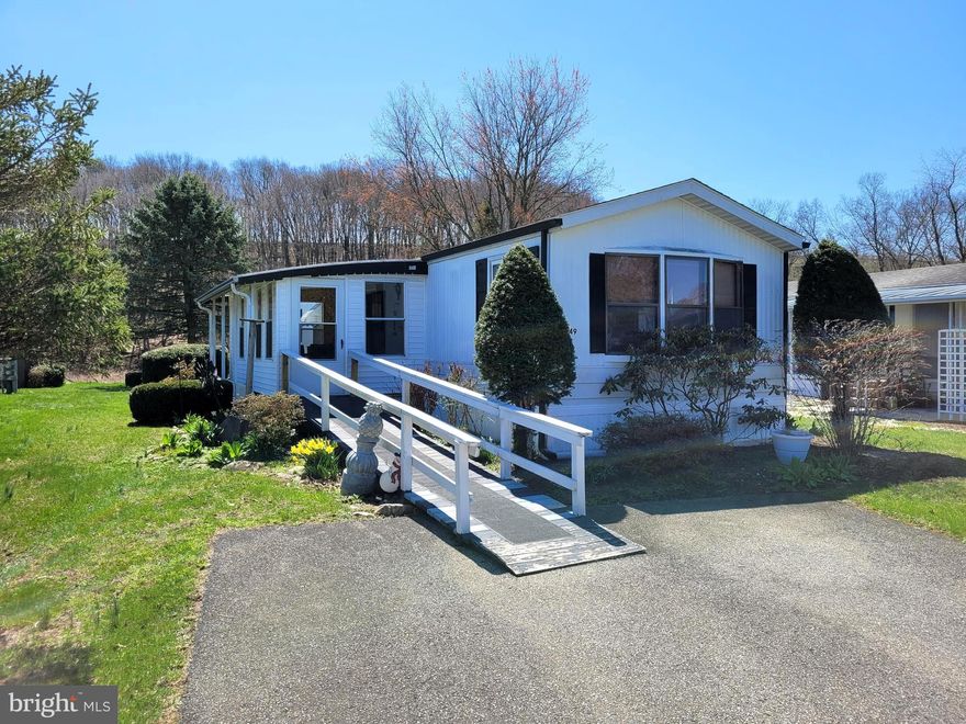 This affordable home offering 2 bedrooms and a full bath is located in the quiet Irish Creek Village.  The eat-in kitchen provides ample space for a table and includes a newer stove, with an open layout connecting to the living room. The spacious primary bedroom features an extended closet for extra storage.  The full bath features a large walk-in shower and a skylight that brings in natural light. Easily accessible, there are ramps leading from the parking and open spaces in the home. An enclosed porch, added just last summer, creates a cozy spot to unwind. The home is heated with a kerosene fuel system that’s been serviced annually, and the A/C unit has been replaced. Additional updates include a newer roof, washer and dryer. All appliances, along with the porch furniture, are included with the home.  Super low taxes and Schuylkill Valley SD!  Lot rent includes water, sewer, trash and roads cleared.