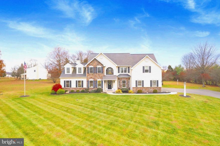 Set on a picturesque 2.82-acre private lot in the highly sought-after Methacton School District, this exceptional residence offers refined estate living just minutes from the shops, dining, and charm of Skippack Village. Built in 2010 and offered for the first time by its original owners, the home has been thoughtfully enhanced with two significant additions, expanding the finished living space to over 4,000 square feet above grade. 

The home’s timeless exterior—accented by classic stonework, dormers, and balanced architectural details—creates an immediate sense of arrival. Inside, a dramatic two-story foyer with a vaulted cathedral ceiling is anchored by a striking arched window that floods the space with natural light. Solid white oak hardwood floors, a grand front staircase with custom railings, and a secondary back staircase highlight the elevated craftsmanship throughout.

The formal dining room showcases a tray ceiling, wall sconce lighting, and custom millwork, while glass French doorsenhance architectural flow. A main-level office/study with bay windows and custom woodwork provides an ideal work-from-home retreat.

The sunken family room addition (2013) features a custom coffered ceiling, 10-foot ceilings, recessed LED lighting, and its own HVAC system. Sliding glass doors lead to the rear patio, creating seamless indoor-outdoor living. The family room is centered around a gas fireplace framed by a dramatic floor-to-ceiling stone wall.

Completed in 2020, the sunroom addition is filled with large Andersen windows and dual sliding glass doors, flooding the space with natural light and offering beautiful views of the private 2.82-acre setting—a perfect place to enjoy all four seasons.

The gourmet kitchen features stainless steel appliances, 42-inch cabinetry with integrated lighting, granite countertops, and stainless steel appliances.

Key systems and features include: two HVAC systems with three-zone climate control, a main home system updated in 2024, 300-amp electrical service, Andersen double-hung tilt windows and doors, and a basement with 9-foot ceilings, egress window, and three sump pumps.

Meticulously maintained and thoughtfully upgraded, this remarkable residence delivers timeless luxury, exceptional craftsmanship, and an unbeatable location—presenting a rare opportunity to own a truly special estate property in one of the area’s most desirable settings.
