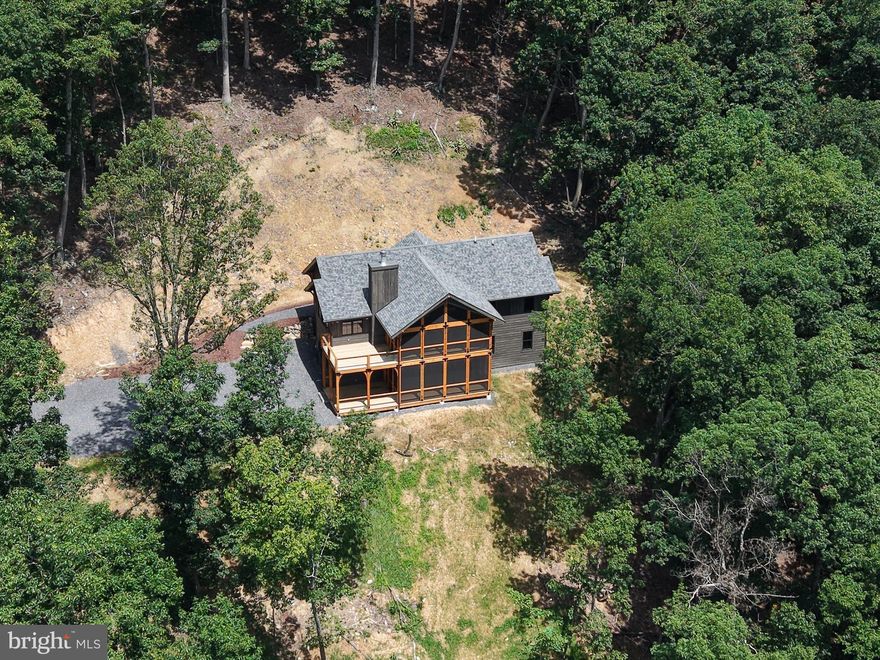 Perfect Mountain Getaway for Second Home Buyers
Final Available Home in The Summit at Lost River
Escape the noise and recharge in this architecturally designed two-level mountain lodge, located in the exclusive Summit at Lost River community. Designed by William DeMaio of Denver, Colorado, this 2,450 sq. ft. home sits on 4.27 private acres and offers breathtaking mountain and valley views — the ideal retreat for weekend escapes or extended stays.
As the final home available in this 34-home community, it represents a rare opportunity. Each property here was carefully placed to ensure privacy, views, and a true sense of mountain living — without sacrificing comfort or connection.
Why It’s Perfect for a Second Home:
Easy access: Just 2 miles from Corridor H with direct routes to I-81 and I-66
 2 hours from Northern Virginia, with new highway reducing drive time by 30+ minutes
High-speed internet & strong cell service — stay connected when you need to
Low-maintenance design and a 1-year builder warranty
No lawn mowing needed — enjoy nature without the chores
Local Charm Meets Outdoor Adventure:
Lost River is a small, welcoming community with just the right mix of amenities:
General Store & Café
Yoga Barn and Farmers Market
The Guesthouse at Lost River: boutique hotel with restaurant, pool, lounge & entertainment
Two stocked lakes nearby: Rock Cliff Lake (with sandy beach) and Kimsey Run Lake (boat ramp)
Seasonal Events & Small-Town Fun:
Lost River 5K — great community energy
Bergton Country Fair and the Bulls & Barrels rodeo draw visitors from near and far
Nearby Moorefield offers essentials, shopping, and dining — just 25 minutes away
With major school renovations, a regional community college 20 minutes away, and infrastructure growth, the area is also poised for long-term value.
Whether you're looking for a peaceful weekend escape or a stylish base for remote work and recreation, this is a one-of-a-kind opportunity in a rare mountain community.