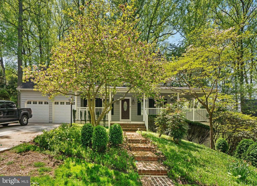 A wrap-around porch guides you into this beautifully updated colonial in Clary’s Forest on a verdant .32 acre homesite in a cul-de-sac featuring refinished hardwoods, freshly painted interiors, new carpet, new light fixtures, kitchen and bathroom upgrades, and more! Step inside to find French doors opening to a quiet study with built-ins, a living room with a French door walkout to the porch, and a formal dining room brightened by a beautiful bay window. Kitchen incorporates bay architecture, refreshed cabinetry, granite counters, a peninsula island with breakfast bar, stainless steel appliances including a new oven, a pantry and a breakfast room with a sunlit bay window with a backyard view and overlooking the family room. Gleaming hardwoods draw your attention to the comfy family room boasting a brick surround wood burning fireplace with a wood niche, and a French door stepping to a sizeable deck with a delightful tree-lined view. Huge owner's suite presents a sitting room with skylights, plenty of closet space, and a sumptuous bath displaying vaulted ceiling, a double vanity, a separate shower, and a claw foot tub to escape after a busy day. Expansive walkout lower level offers the chance to create the rooms of your dreams in the unfinished basement with tons of possibilities currently offering plentiful storage.