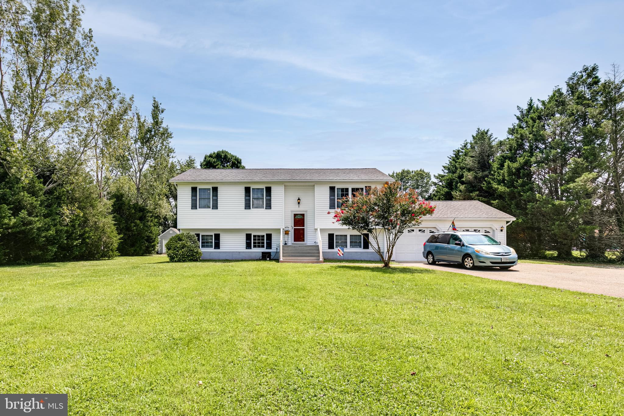 OPEN HOUSE SATURDAY 8/14, 12-3PM! This wonderful split-foyer on a private 1-acre lot, has been carefully maintained and is being sold by the original owner. Located just outside of town, but only a 5 minute drive from the Patuxent River Naval Air Base, AND only about 10 minutes from all of your favorite shops and restaurants; this home is everything you’ve been hoping for in this area!
On the upstairs level you are first welcomed into the living room which boasts a tall, vaulted ceiling that continues into a very spacious kitchen/dining room. A sliding glass door in the kitchen provides lots of natural light, and grants access to the elevated wood deck which includes a retractable awning. Down the hall you will find 3 bedrooms and 2 full baths.
A HUGE addition on the backside of this home allowed the owner to convert the original master into a private lounge for the head of household(s) that walks through to the added luxurious master bedroom. This includes a walk-in closet and an en-suite that is also accessible from the fore-mentioned lounge area. Climate in the addition is independently controlled by it’s own dedicated heat pump.
Headed down the stairs, you find a mostly finished basement, with ample room for activities.. JUST ADD FLOORING! This basement includes a 4th bedroom, a small office, a 3rd full bathroom, a second living room with a wood-pellet fueled stove, a laundry room, and a very spacious recreation room separated by french doors. This level has access to the backyard as well as the two car garage.
Attic storage space can be found pretty much everywhere in this home. There is an attic above the original bedrooms, one above the addition and another above the garage. Two sheds also convey with the property. The property is mostly cleared aside from some carefully placed Green Giant Evergreens for privacy, and other mature trees including: Crepe Myrtle, Red Maple, Black Maple, Black Poplar and Loblolly Pines. A new french drainage system has been installed on the property. Property is conveying AS IS. OFFER DEADLINE: Sunday 8/15 at 9pm.