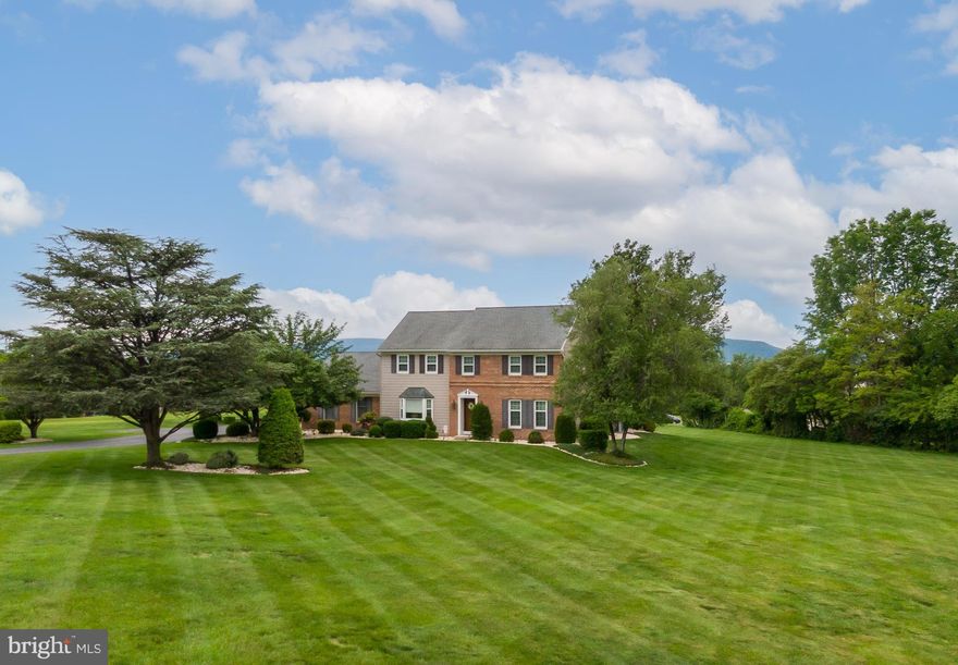 Location, location, location!  This 2 story colonial has a rural setting, yet is within 5 minutes from stores, pharmacies, restaurants, breweries, schools,  Route 61, and has easy access to I78.  These original owners have updated the house over the years with a new kitchen, new bathrooms, replacement roof, tilt-in replacement windows, new electrical panel,   new Trex decking on porch, stamped concrete patio,  and new flooring.  The first floor is great for entertaining! The open flow will include the family room, kitchen, and large dining room.   The white cabinetry kitchen has an  8' long island that seats 5 people, has pull-out drawers, and plenty of countertop prep area for cooking.  There is recessed LED lighting, under-cabinetry lighting, and Quartz countertops.  The large slider kitchen windows will give you  magnificent views of the Blue Mountains.  The entire first floor has luxury vinyl plank flooring.  Located off the kitchen is the family room that has a propane fireplace on a tiled wall and floating shelves.   The dining room has a lot of natural light with the bow picture window.  Also, on the first floor is a living room that has crown molding, powder room, and the laundry room.  The 2nd floor consists of 4 bedrooms and 2 bathrooms.  The ensuite has a tiled walk-in shower, tiled floors, and  counter-height double sink vanity.  There is a walk-in closet off the master bedroom.  All the other bedrooms have double closets.  And if you want to entertain during the summer, there is plenty of room on the stamped concrete patio area and new Trex porch area (installed in 2024).  You can relax in the evening by seeing the most amazing sunsets from the deck!  The parcel consists of 2.5 acres and will give you plenty of yard area for your kids to play or pets to run.  The house is located on a private drive with a cul-de-sac and is shared with 1 neighbor; there is a written maintenance agreement for the shared portion of the driveway.  Call today for a showing!  Both owners are PA licensed realtors.