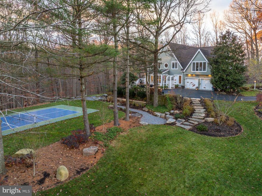 OPEN HOUSE CANCELLED - HOUSE IS UNDER CONTRACT.  Quietly tucked away within the gated community of Overlook, lies the most picturesque woodland retreat. Situated on over 3 acres, with direct access to Loch Raven Reservoir and endless trails, this custom-built home is a true ‘feel good house’ from the moment you arrive. A refreshing shift from the ordinary with walls of glass and oversized windows overlooking your tranquil surround. An ever-changing backdrop to connect you with each new season. Step inside and feel at home. A thoughtful floor plan with a well-balanced blend of open spaces and designated rooms. Seamless connection from kitchen and family room, anchored with an eye-catching oversized stone fireplace and doors calling you out to expansive deck. Gather for casual meals in your glass encased breakfast nook that gazes out over your park-like property, complete with your very own versatile sports court. Spacious dining room lined in glass flows into sunken great room with cathedral ceilings and interesting angles. Step upstairs to your spacious primary suite, wrapped in glass overlooking a row of tall stately pines. Second floor is complete with three additional generously sized bedrooms and two beautifully updated bathrooms. Fully finished, walk-out lower level with bedroom, full bath, and large open recreational space. Step outside to fire pit and sports court through your lower-level mudroom. The perfect place to house all of your sporting equipment, out of the way of your every day. Create lasting memories with family and friends as you engage in friendly competitions while maintaining a healthy and active lifestyle within the comfort of your own home and surrounded by the beauty of nature. With extensive hardscape, well planned landscaping, and stunning outdoor lighting by Gavrelis & Associates, this is the ideal property for family gatherings and outdoor activities. Envision closing your day with leisurely strolls in your very own oasis of a neighborhood, shielded from outside noise and the commotion of everyday life. Discover a lifestyle where conveniences of modern living melds with the serenity of nature. This home is not just a dwelling; it is an experience — the embodiment of comfort, activity, and natural beauty. Cultivate your existence. The art of uniting human and home. 
***PLEASE NOTE*** Showings will begin at Open House Wednesday, February 7th 12:00 - 2:00 pm.
**Showings will be LIMITED to Wednesday and Thursday this week. Property will NOT be available for showings Friday (2/9) or Saturday (2/10). Showings will resume Sunday, February 11th at 1:00 pm**