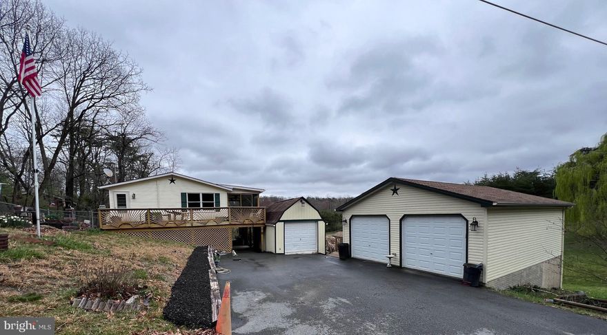 This ranch style home situated on 1.23 acres offers plenty of storage space with a 2 car detached garage and 3 additional outbuildings. Outside, in addition to the outbuildings, you will find an inground pool surrounded by a chain link fence. Entering into the home from the basement level you will find a large family room, a bathroom, and a laundry/utility room. On the main level of the home you will find the kitchen and living room, the two bedrooms, and a bathroom. The kitchen and living room both boast cathedral ceilings. While the seller does not currently have propane hooked up there is a propane fireplace in the living room. From the living room you can access the screened in porch that expands the length of the home and overlooks the property.