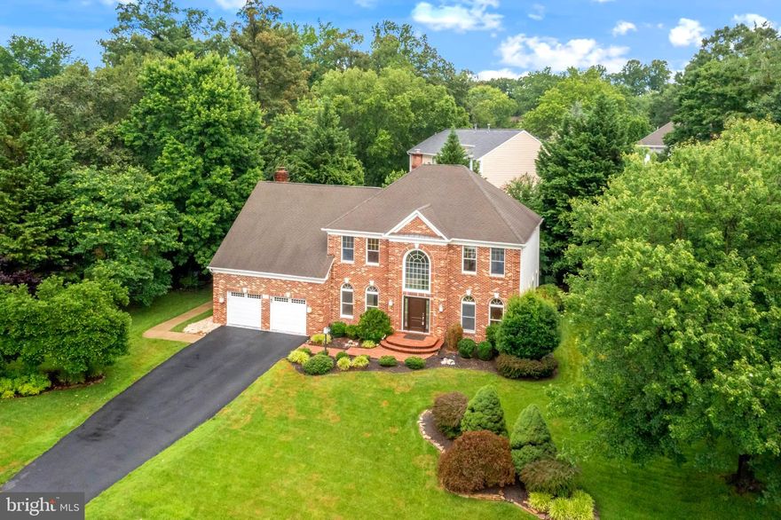 Highly sought after, but rarely available! Welcome to the Barrington community of Fairfax Station! The expansive front yard makes an immediate visual impact with great curb appeal. This 4,826 sq ft 4-bedroom 5-bath house with 2-car garage is located on a quiet cul-de-sac with a long driveway large enough to park six additional vehicles. Upon entry, you’re greeted by a soaring two-story foyer. Immediately, you’ll appreciate the clean lines and contemporary designs throughout the house. This property boasts a dedicated home office, formal living room, and dining room with bay windows, three-piece crown molding and chair rails. The main-level bathroom is a full bath! Convert the office into a main level bedroom, and this can be a perfect multi-generational home! The kitchen is modern with black slate countertops and crisp white cabinets, and stainless-steel appliances including a wall-oven, built-in microwave, and an overhead exhaust vent. The contemporary eat-in kitchen opens to a bright and airy sunken family room with vaulted ceilings, skylights, warm toned hardwood flooring, and floor-to-ceiling brick gas fireplace. A bathroom and laundry/mud room with access to the garage round out the main level. Upstairs, the spacious primary bedroom has a large yet cozy sitting room with a built-in electric fireplace. This expansive primary suite boasts three closets, with one of them being a walk-in with built-in shelving, along with an attached primary bath with soaking tub, walk-in shower, and double vanities. Three additional bedrooms and two additional bathrooms are located on the upstairs level.  The basement is fully finished with a large recreation room, a bonus room perfect for a home gym, a full bathroom, and a wet bar. Outside, you will find a large deck off the kitchen perfect for entertaining friends as well as a flagstone patio. In-ground irrigation system to keep your lawn emerald green! HVAC replaced in 2022 along with dual zone AC units replaced in 2021 and 2022. Two secondary bathrooms updated in 2024. House repainted on main and upstairs levels in 2025.  At this amenities-rich community, you can enjoy basketball courts, tennis courts, swimming pools, clubhouse, bike/jogging trails, and playgrounds. This community has quick and easy access to major commuter routes including Rt 123, Rt 286, I-95 and approximately 10 minutes from the Virginia Railway Express (VRE) in Lorton. Grocery stores, restaurants, and retail shopping conveniently just minutes away. This home is zoned for South County High School, South County Middle School, and Silverbrook Elementary. Don’t miss this opportunity to own a gorgeous property in a prime Fairfax County location!