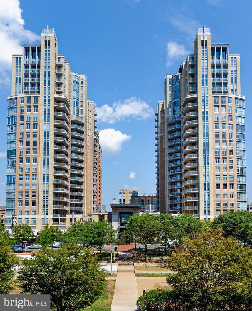 Welcome to your new home with breathtaking views from every angle -  north, east, south, and west – sunrise to sunset. This inviting upscale, one-level design is the perfect choice for those ready to down-size or right-size their home and live their best life.  Enjoy a new accessible and manageable living environment in the heart of Reston Town Center with impressive unobstructed views of the Blue Ridge Mountains. Your new home features open concept living and dining spaces that create a spacious and inviting atmosphere making it perfect for entertaining guests and hosting family gatherings. Tailored window treatments, a built-in bar with beverage center, and the electric fireplace enhance your living space. A wrap-around balcony off the dining room provides additional living and entertaining space during warmer months and is the perfect spot to relax and enjoy your incredible urban landscape. A gourmet kitchen includes upgraded cabinets with roll-out shelves, luxurious granite countertops, stylish tile backsplash, stainless-steel appliances, breakfast bar, and a pantry with ample storage space. Two ensuite bedrooms enable maximum privacy and convenience for family or guests. An additional 3rd bedroom can create the ideal space for the at-home worker, crafter, or exercise buff with an accessible hallway full bath. Start each morning or retire at the end of a long day taking in the mountain view backdrop in an amazing sunroom with floor to ceiling windows just off your primary bedroom. Added features include spacious laundry and storage area with full size washer and dryer and automatic water detection and shutoff system, two deeded parking spaces (3086 & 3087) and a deeded storage unit (97). On-site property management, 24/7 concierge provides security and convenience. Resident amenities include a library, two guest suites, private movie theater, conference room, fitness center, party room, patio grills, outdoor swimming pool and hot tub. Being in close proximity to fine dining, shopping, a skating rink, concerts, and the W&OD trail provides a wealth of opportunities for leisure, entertainment, and exercise. Nearby access to IAD and Reston Town Center Metrorail Station makes for easy travel and commuting.  The seller is offering a one-year home warranty through Cinch Home Services, providing you peace of mind.