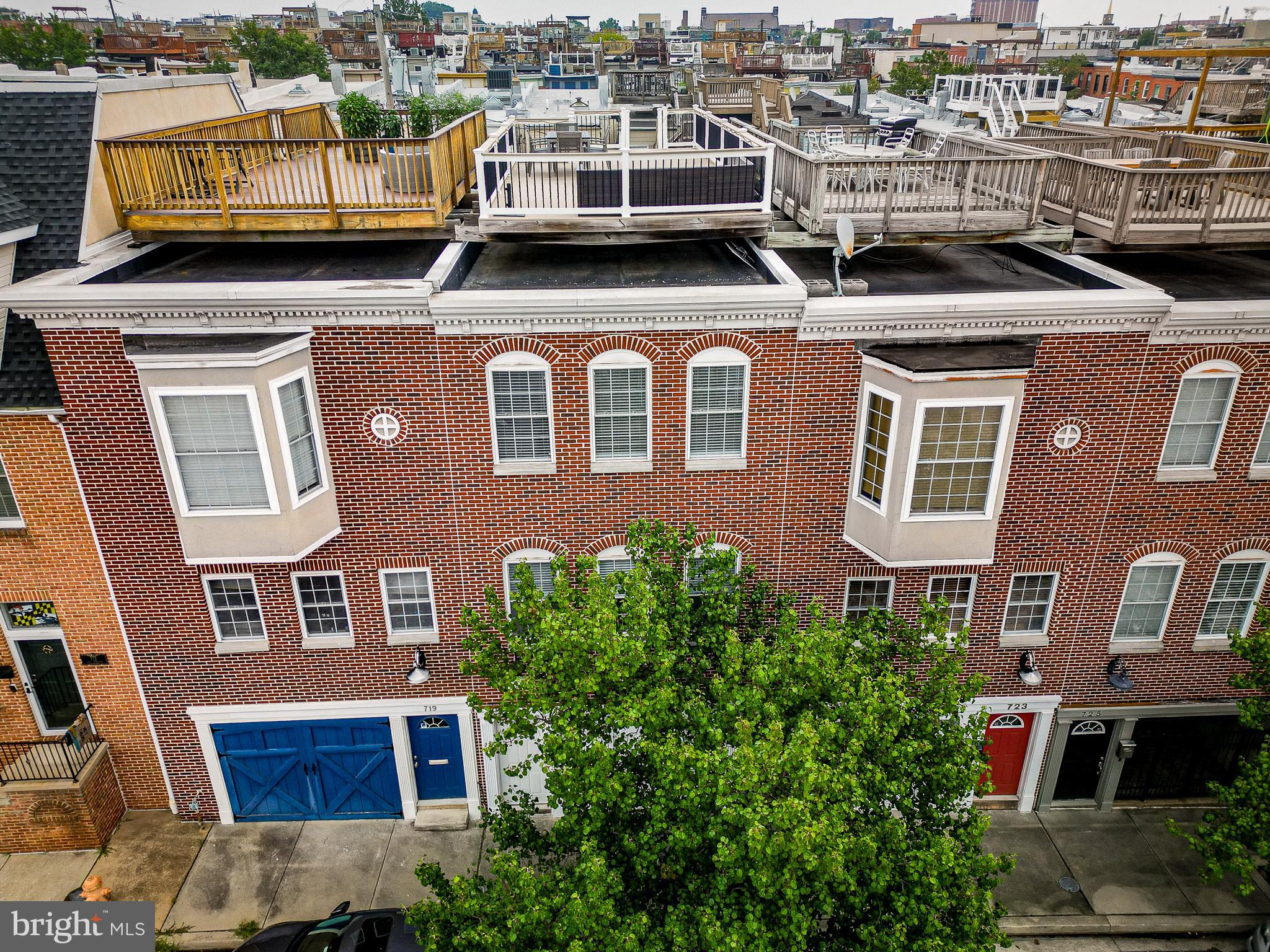 Exceptional Brick Row Home with spectacular view in the Heart of Canton with rare Two-Car Parking! Built in 2003, this beautifully maintained home offers a spacious, open layout that blends style and function in one of Baltimore’s most vibrant neighborhoods. The main level features soaring ceilings, abundant natural light, and rich hardwood floors flowing through generous living and dining areas. A chef’s kitchen anchors the space with granite countertops, stainless steel appliances, an oversized island, 42” cabinetry, and thoughtful extras like a built-in spice rack perfect for cooking and entertaining. Upstairs, you'll find two large bedrooms, including a serene primary suite with dual closets, plush carpeting, and a spa-like bath featuring a jetted tub and walk-in shower. The second suite boasts private access to a sprawling Trex rooftop deck with stunning city views ideal for relaxing or entertaining under the stars. The entry level adds versatility with a separate living area or bedroom, full bath, and welcoming mudroom perfect for guests, a home office, or fitness space. All of this, close to Canton’s top restaurants, waterfront parks, and local shops, with easy access to I-95, I-83, I-695, and downtown.