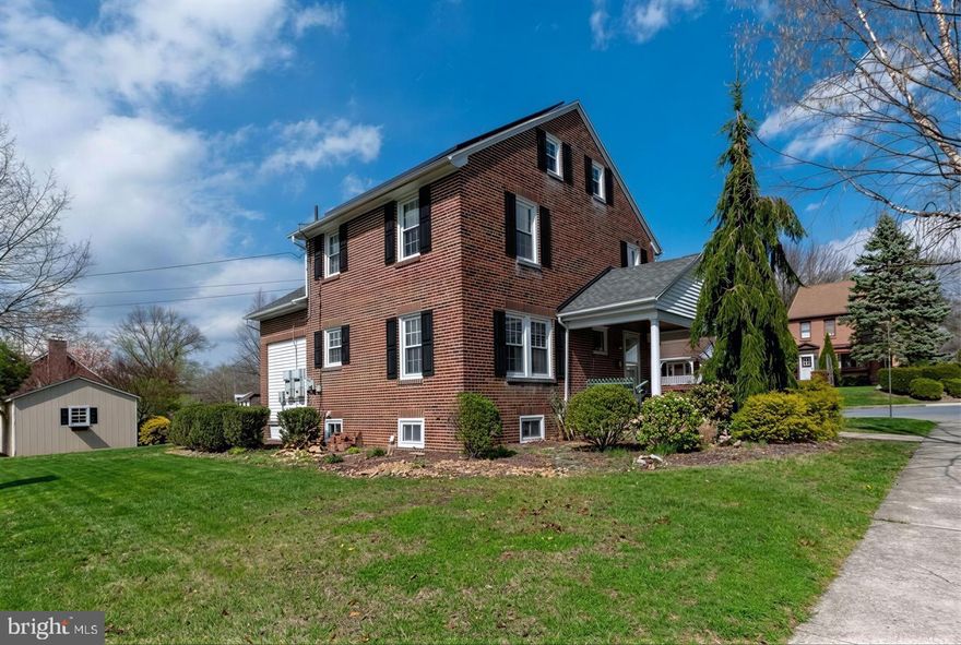 Solid, stately, and full of character, this brick colonial sits proudly on a corner lot in a highly sought‑after neighborhood and school district. From the moment you arrive, the charm is undeniable. A one‑car garage with inside access, an oversized driveway, and a welcoming covered front porch complete with a porch swing set the tone for what’s inside. Out back, enjoy a private yard, a spacious deck, and an impressive 12×20 shed with electric—perfect for hobbies, storage, or a workshop.  And here’s the real win: affordability. With rising utility costs everywhere, this home stands out thanks to its Tesla solar panel system, giving you long‑term savings and predictable energy bills.  Inside, the home offers generous room sizes and beautiful hardwood floors throughout. The living room features a cozy fireplace and a charming Dutch door, while the dining room is ready to host your gatherings. The kitchen is well‑equipped with a smooth‑top electric stove, dishwasher, built‑in microwave, refrigerator, garbage disposal, and a double pantry—plus convenient access to the back deck.  Upstairs, you’ll find three comfortable bedrooms and a full hall bath. The third floor provides an additional bedroom or office (accessed through another room), offering flexibility for today’s lifestyle needs.  The basement is a true bonus space, offering a waterproofing system installed by a prior owner, natural gas heat and hot water appliances, a laundry area with washer, dryer, and utility sink....and a full bathroom, featuring an oversized stall shower.   There is also a unique under-porch unfinished room ideal as a cold cellar or potential wine cellar.   Additional upgrades include replaced windows throughout (with the exception of one accent window in the living room), economical natural gas heat and hot water, and thoughtful improvements made by the current owner.  To top it off, the home comes with a one‑year AHS home warranty as a gift at settlement.   New buyer must assume the Power Purchase Agreement with Tesla for the service of the solar panels.   Listing agent has a copy of the full agreement which is available for review upon request.