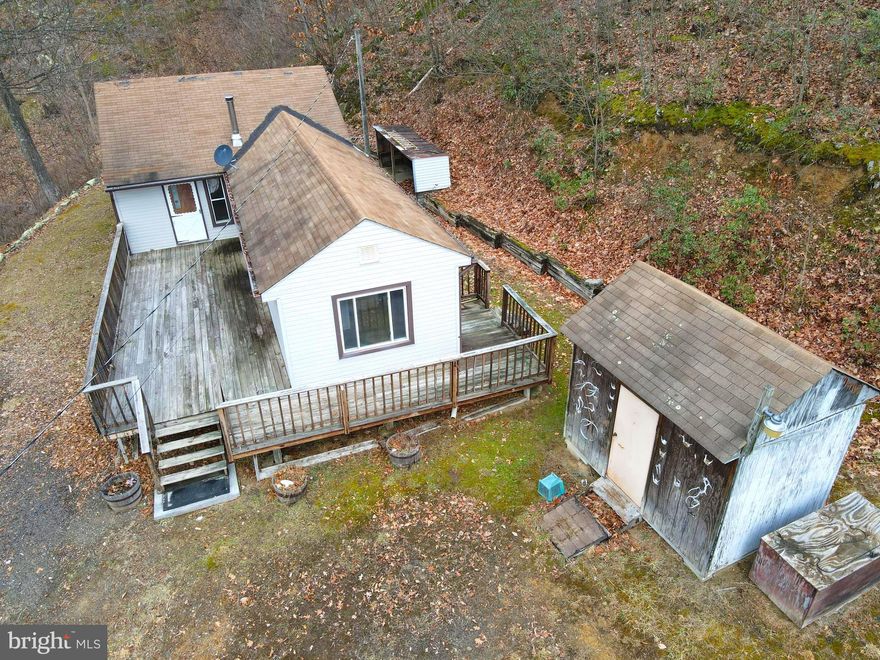 Call now to see this get away in the mountains located on over 29 wooded acres.  This property has two bedrooms, one bathroom, living room, kitchen and utility room with wrap around deck on two sides and a shed. Most of the property is beside and behind the house and is remote. Enter through the private gate and wind up the mountain on and on so you can look for any type of wildlife including deer,  bear, turkey to name a few.  There is one more property  owner on the top of the mountain who uses this road. It is 4 wheel drive rough and steep. If you are looking for some peace and quiet and mountain views then this may be for you. The dwelling needs some tlc but has electric, septic and well but the water line needs replaced for inside use. Move to West Virginia and become a Mountaineer.