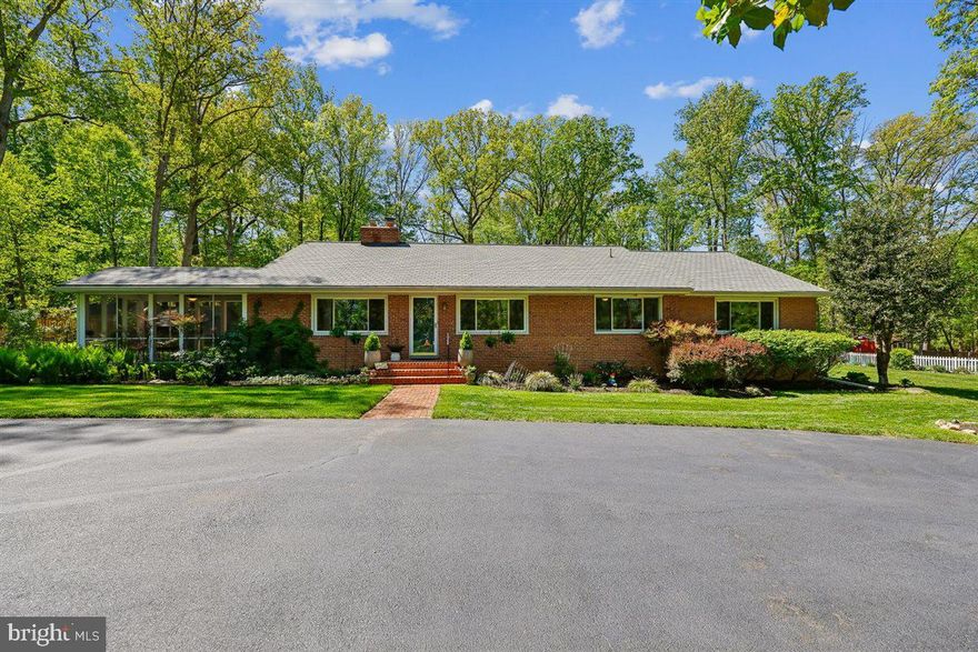 Discover this charming 5-bedroom, 2.5-bathroom ranch-style home nestled in the desirable Sycamore Acres. Built in 1954, this well-maintained brick residence boasts a spacious 2,948 sq. ft. of finished living space, perfect for modern living. Step inside to find an inviting open floor plan featuring hardwood floors and recessed lighting throughout. The kitchen is a highlight, offering ample table space, an eat-in area, upgraded countertops, and essential appliances including an ENERGY STAR refrigerator, wall oven, and dishwasher. The primary suite includes a private bath, while additional bedrooms provide flexibility for guests or a home office. Enjoy cozy evenings by the fireplace with elegant mantel, or step outside to the screened and enclosed patio, ideal for entertaining or relaxing amidst nature. The property sits on over an acre, backing to serene wooded views, ensuring privacy and tranquility. Additional features include a fully finished basement with walkout access, a storage barn/shed, and a circular paved driveway for convenient parking. The lot is situated on a no-thru street, enhancing the peaceful atmosphere. This home combines comfort, style, and a connection to nature, making it a perfect retreat while still being close to local amenities and the ICC (Rt. 200). Don’t miss the opportunity to make this exceptional property your own!