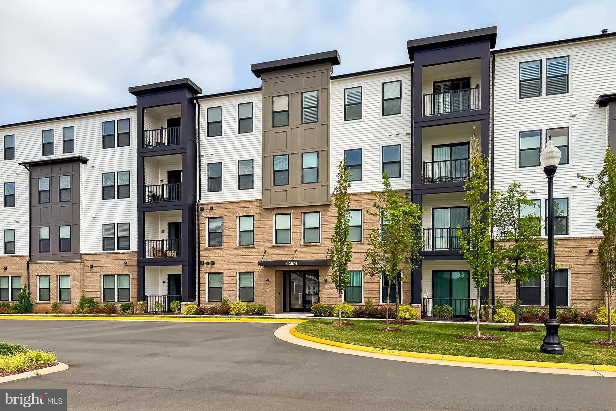 Welcome to this nearly new 2-bedroom, 2-bathroom McCoy model condominium, built by Van Metre Homes and located in the sought-after, gated 55+ active adult community of Birchwood at Brambleton. Offering over 1,250 square feet of beautifully finished living space, this stylish condo is less than two years old and shows like new.
Enjoy the convenience of single-level living with modern upgrades throughout. The home features a rear-load 1-car garage located just across the hallway from your front door—ideal for keeping your vehicle protected and providing extra storage. Step inside to find an open floor plan that seamlessly connects the living spaces, starting with a gourmet kitchen featuring premium cabinetry, quartz countertops, stainless steel appliances, an optional backsplash, and a large center island perfect for meal prep, casual dining, and entertaining.
Luxury vinyl flooring runs throughout the home, offering a sleek look with low maintenance. The spacious living room is filled with natural light thanks to large windows and a sliding glass door that leads to your private patio—a perfect spot to relax and unwind.
Down the hall, you’ll find a comfortable guest bedroom with generous windows and a walk-in closet, as well as a full guest bath featuring floor-to-ceiling tile in the tub/shower, a comfort-height vanity, and granite countertops. The primary suite is a serene retreat with ample space, an oversized walk-in closet, and a luxurious en-suite bathroom complete with dual sinks, abundant counter space, a seamless glass shower with bench seating, and elegant floor-to-ceiling tile.
Additional upgrades include LED recessed lighting, pendant lights over the island and dining area, and ceiling fans throughout to enhance comfort and energy efficiency.
Birchwood at Brambleton offers an exceptional lifestyle with two state-of-the-art clubhouses, indoor and outdoor pools, a fully equipped gym, locker rooms, pickleball courts, an art studio, card room, private event spaces, walking paths, community ponds, and more. Condo fees cover water, sewer, trash, cable, internet, clubhouse access, and security within this gated community. An on-site manager and pool lifeguards provide added convenience and peace of mind.
Don’t miss the stunning water views from the clubhouse and all the amenities this vibrant community has to offer. Come experience the best of 55+ living at Birchwood at Brambleton!